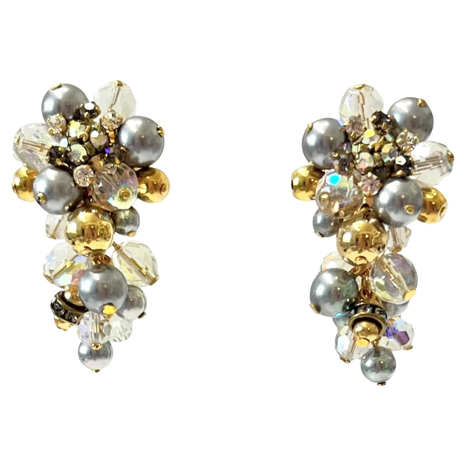 Green , opaque clear and gold glass beads clip earrings inspired after a bunch of grapes from French design house Francoise Montague. 
Francoise Montague took over the De Saurma jewelry workshop in the late 1940s. Her mother founded the workshop in