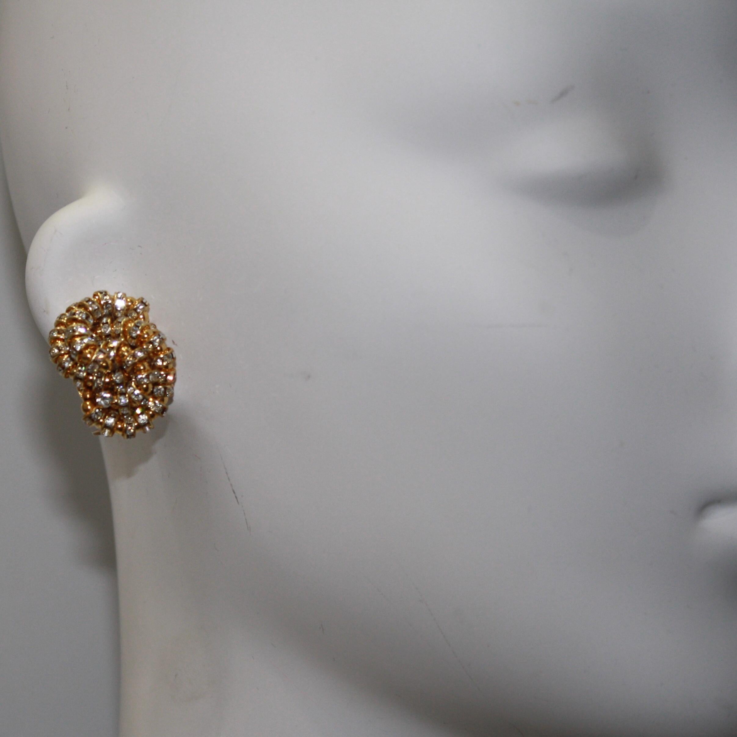 Swirls of Swarovski crystal rondelles set on gold metal.
A classic design by Francoise Montague . Fits perfectly on the ear.
Francoise Montague took over the De Saurma jewelry workshop in the late 1940s. Her mother founded the workshop in 1945,