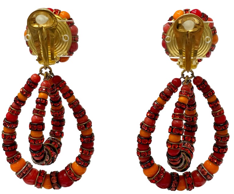 This an iconic style from designer Francoise Montague in a mix of orange hue. Made with Swarovski Crystal rondelles and handmade glass beads . These are clip earrings. 

Francoise Montague took over the De Saurma jewelry workshop in the late 1940s.