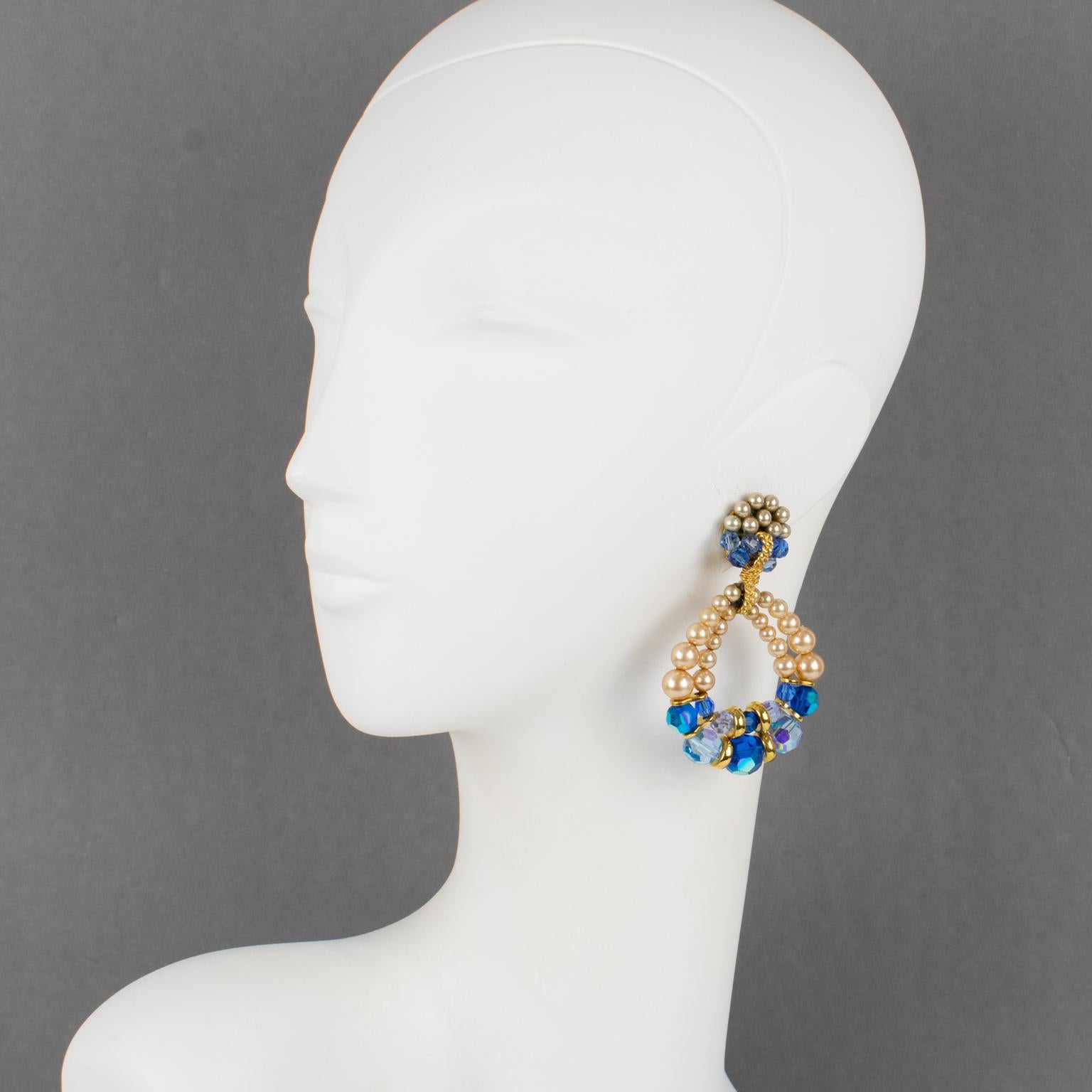 Francoise Montague Paris designed these exquisite dangling clip-on earrings. The iconic Lolita shape style has a handmade double hoop design ornate with cobalt blue and baby blue crystal faceted beads and pearl-imitation beads. The pieces will come