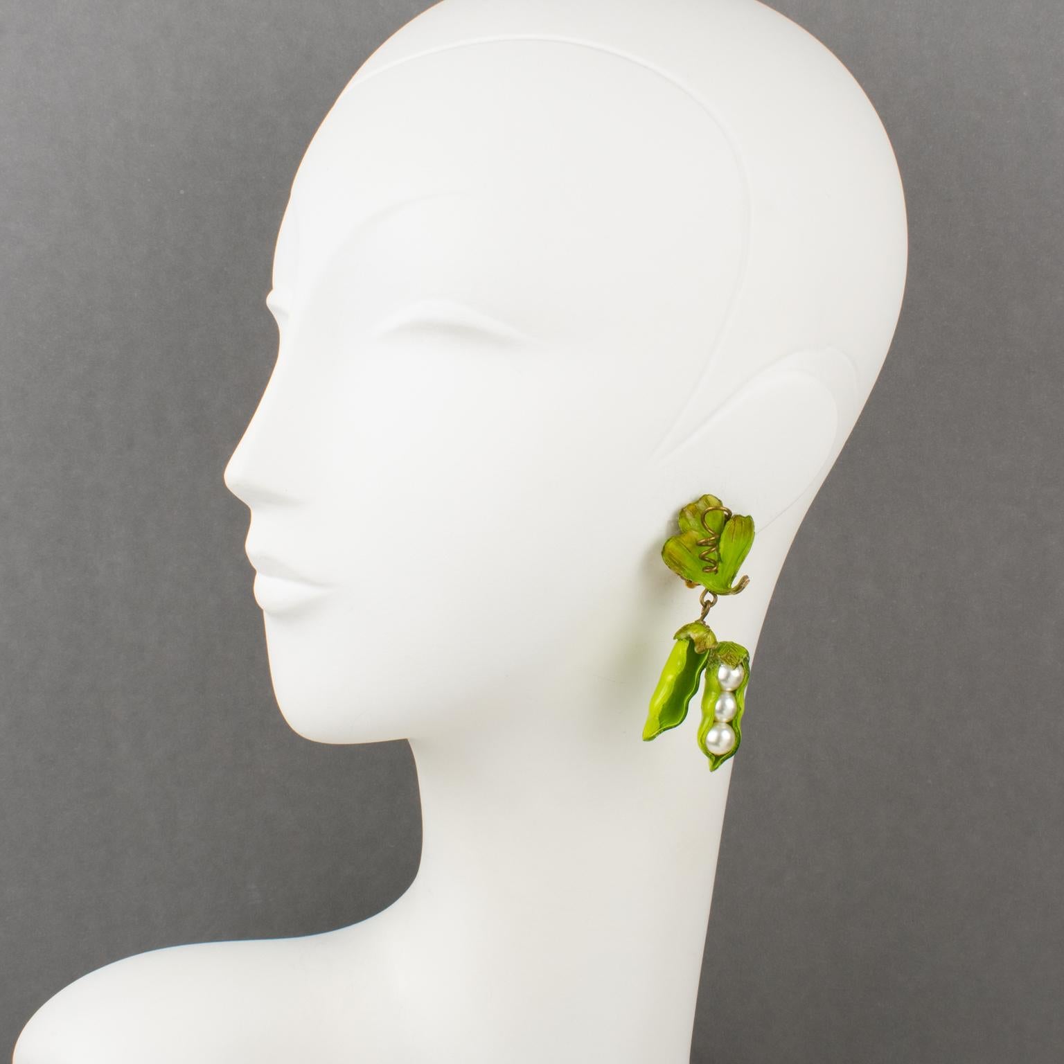 So cute French Jewelry Designer Francoise Montague Paris clip-on earrings. Dangle shape, in resin featuring dimensional green pea with pea pods and leaves in fresh green color. The peas are in pearl-imitation beads. No visible signature like all the