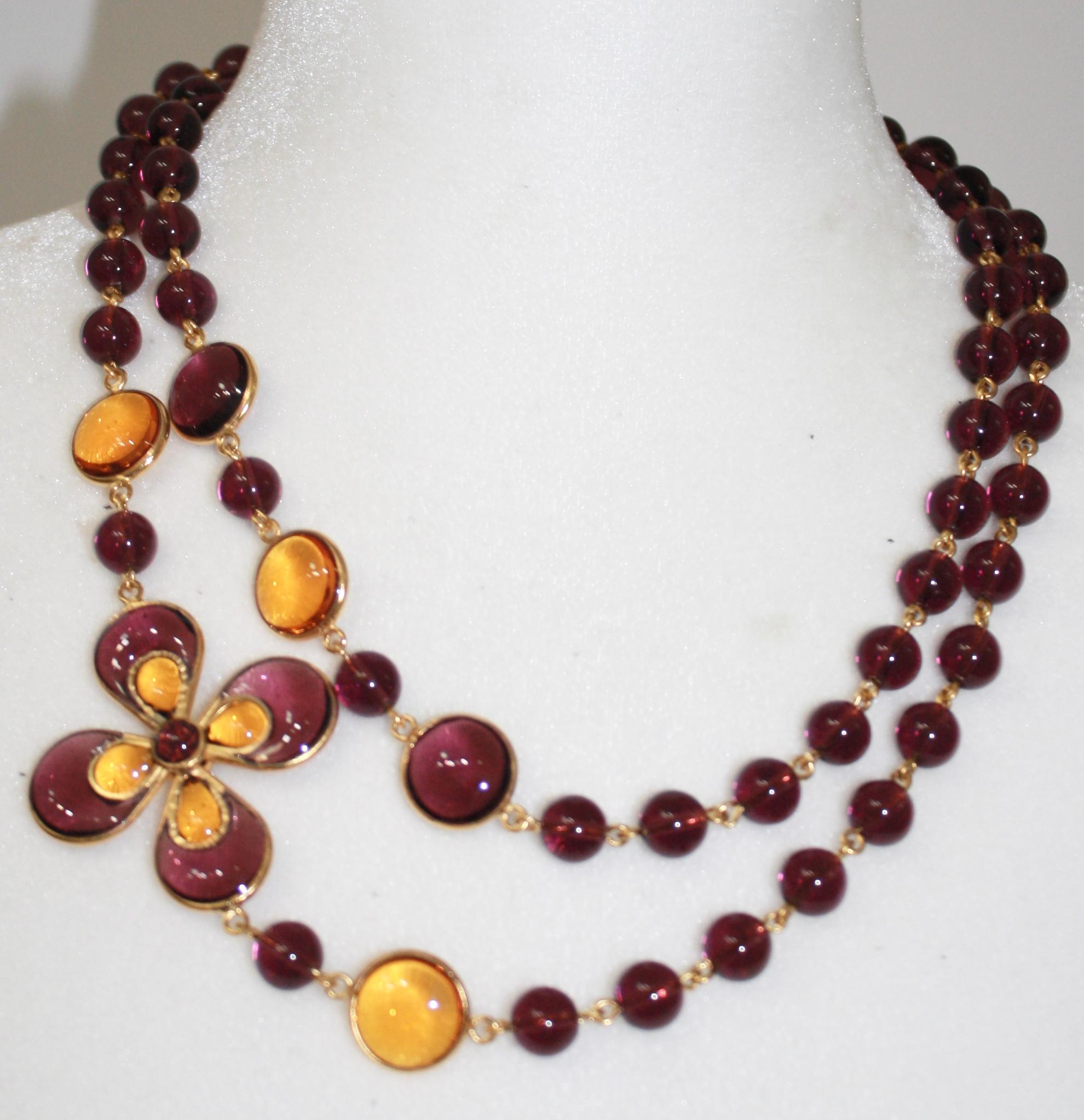 Purple and gold Gripoix work late de verre necklace . Can be worn doubled as well .
Flower motif is 1.75”