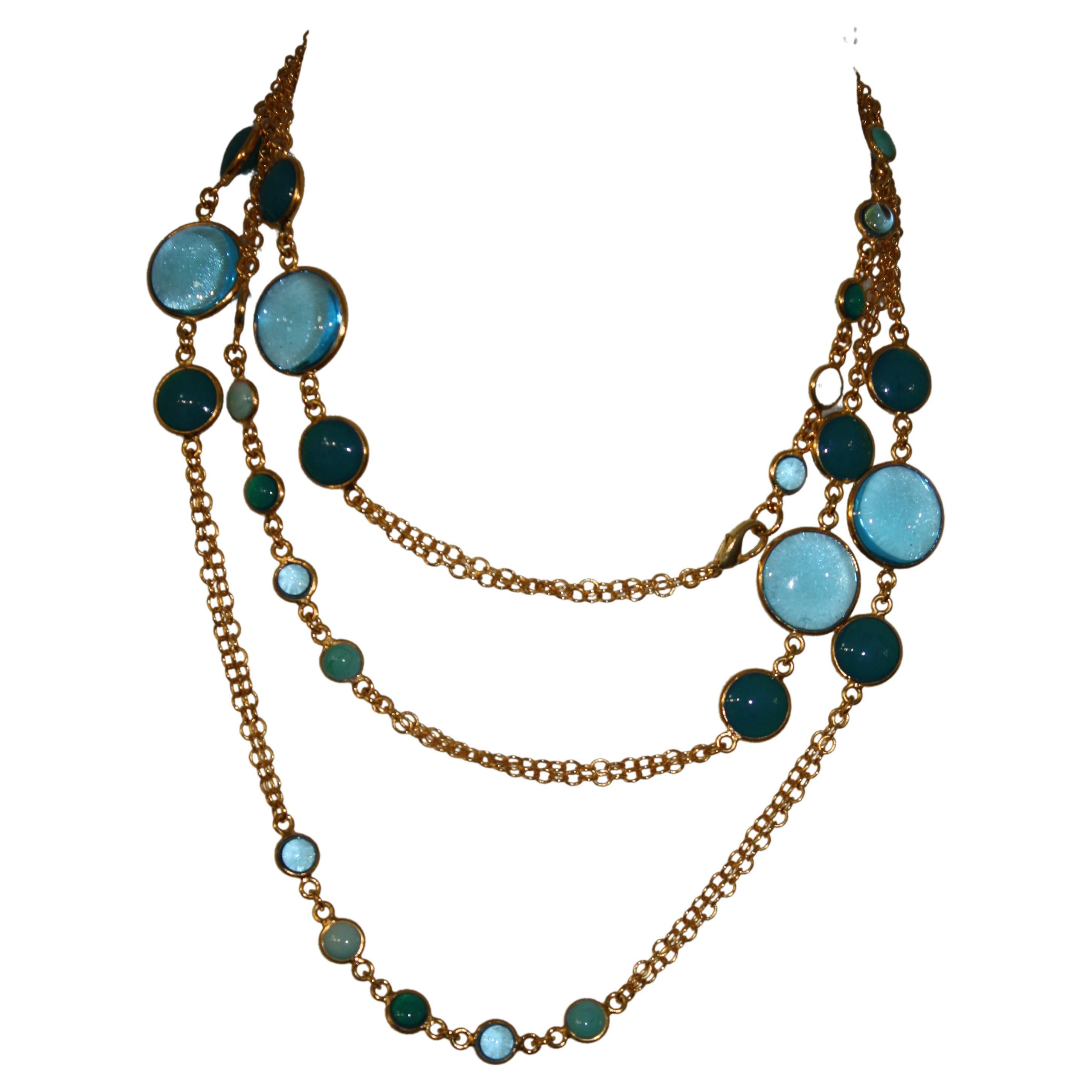 Gilded brass chain and pate de verre pastilles in shades of blue and turquoise . Necklace is very long and can be doubled and tripled.
A classic from Francoise Montague collection. Made in Paris