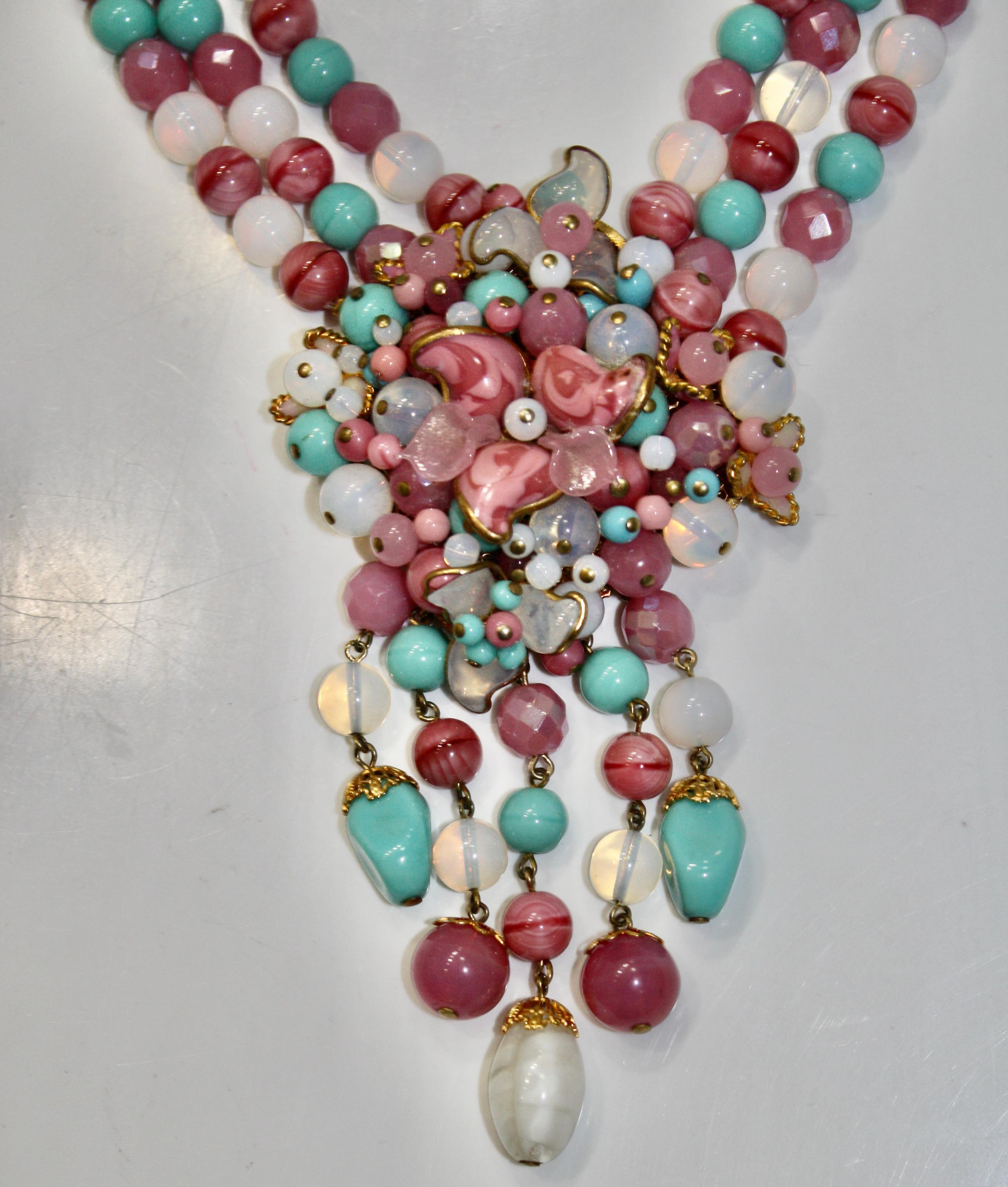 Pink, white and aqua pate de verre necklace made with the Gripoix savoir faire. Delicate flower on the center motif.
5” drop and 3” extension chain .
From the atelier of Françoise Montague.