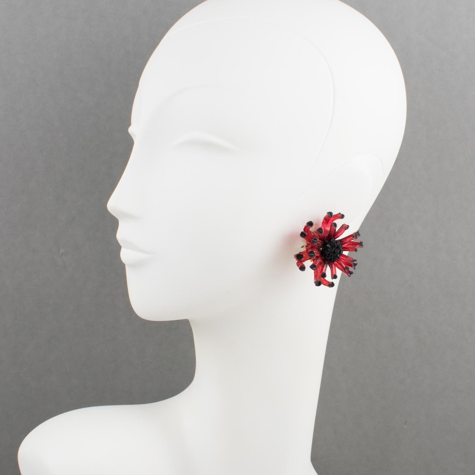 These stunning French Jewelry Designer Francoise Montague Paris resin clip-on earrings feature a dimensional anemone flower shape with raspberry red and black colors. There is no visible maker's mark since none of Montague's vintage resin jewelry is