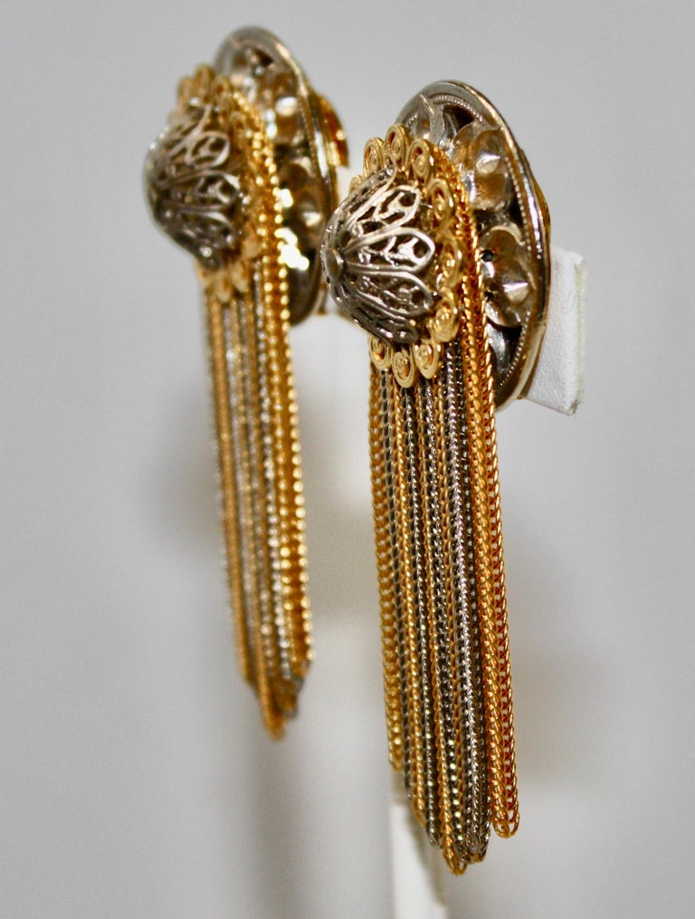 Clip earrings with vintage elements in silver and gold rhodium. Delicate metal work on the clip. Multi chain drop