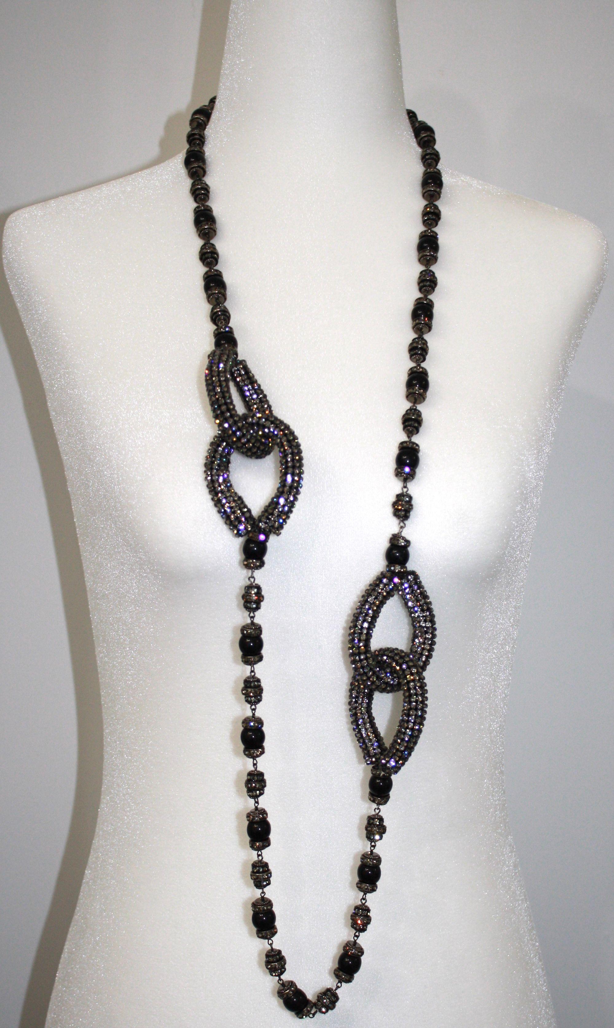 Long sautoir that can be wrapped around into a choker. Handmade glass beads and swarovski crystal set on black metal.