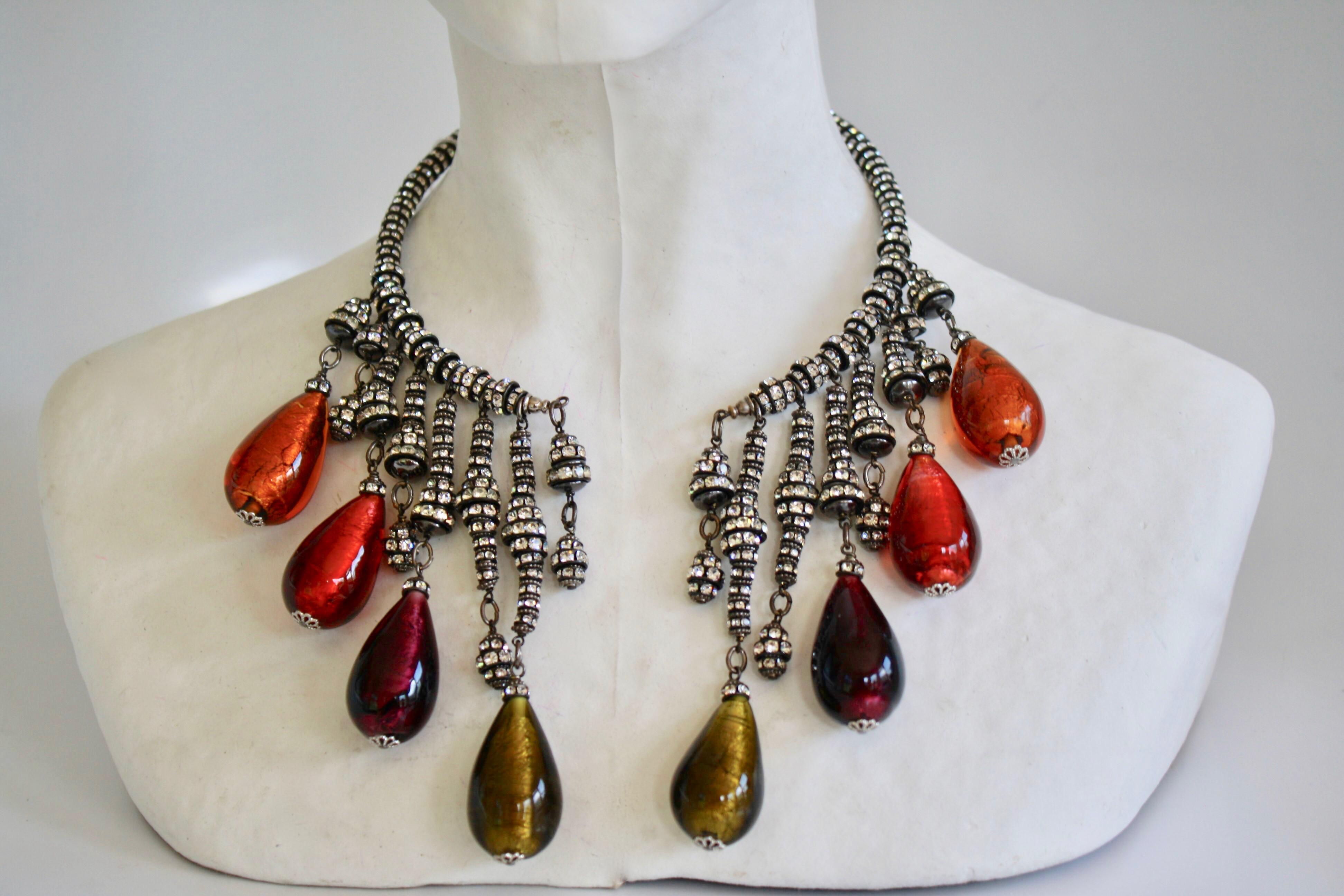 Phenomenal handmade necklace from Francoise Montague Paris. Comprised of Swarovski crystal rondelles on black metal with graduated multi color venetian glass drops. Opens to the front. 
13” around
longest drop is 4”