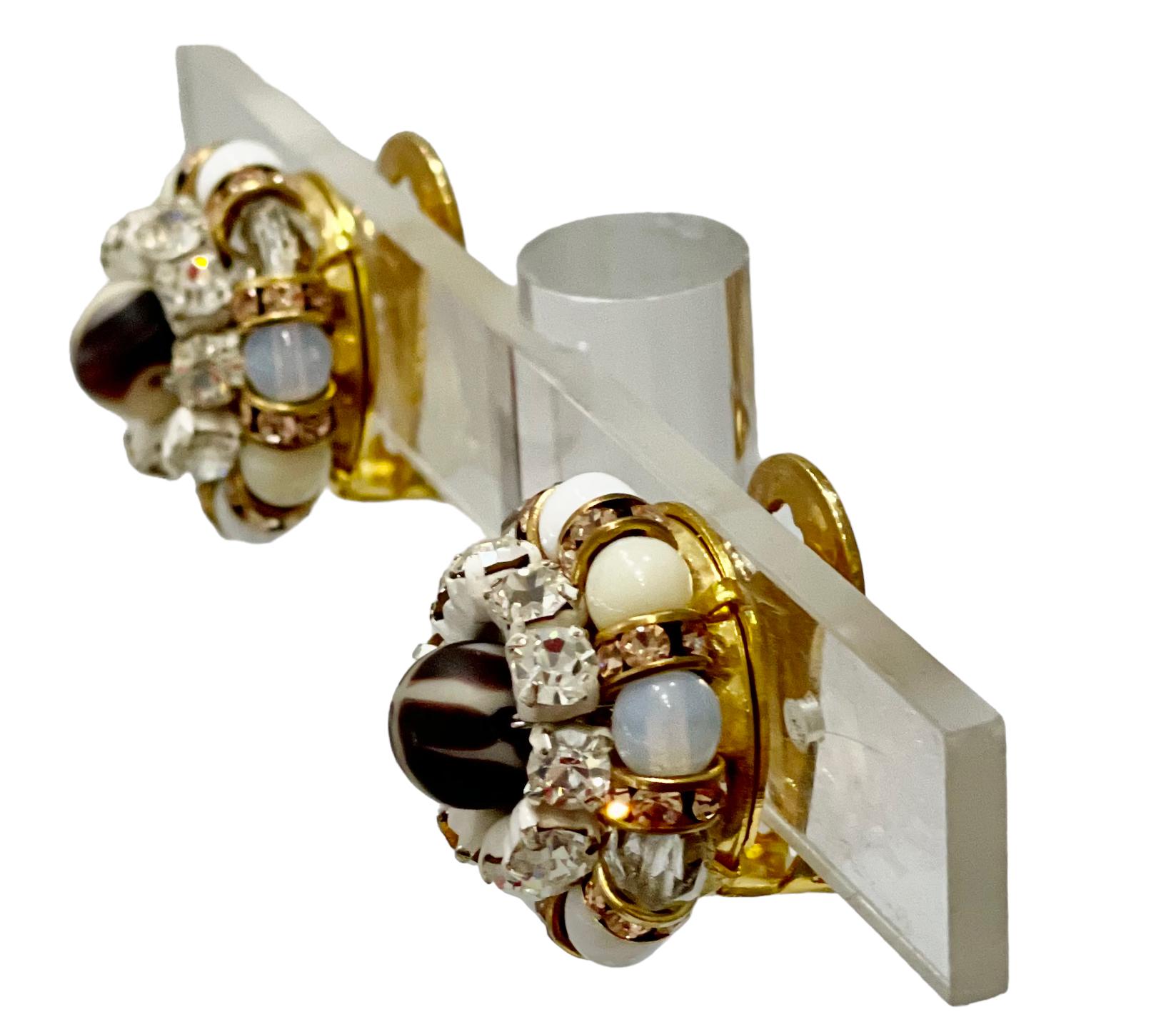 Handmade glass cabochons in white and spotted white. Swarovski Crystal rondelles, iconic of Françoise Montague designs.
Clip Earrings.
Francoise Montague took over the De Saurma jewelry workshop in the late 1940s. Her mother founded the workshop in