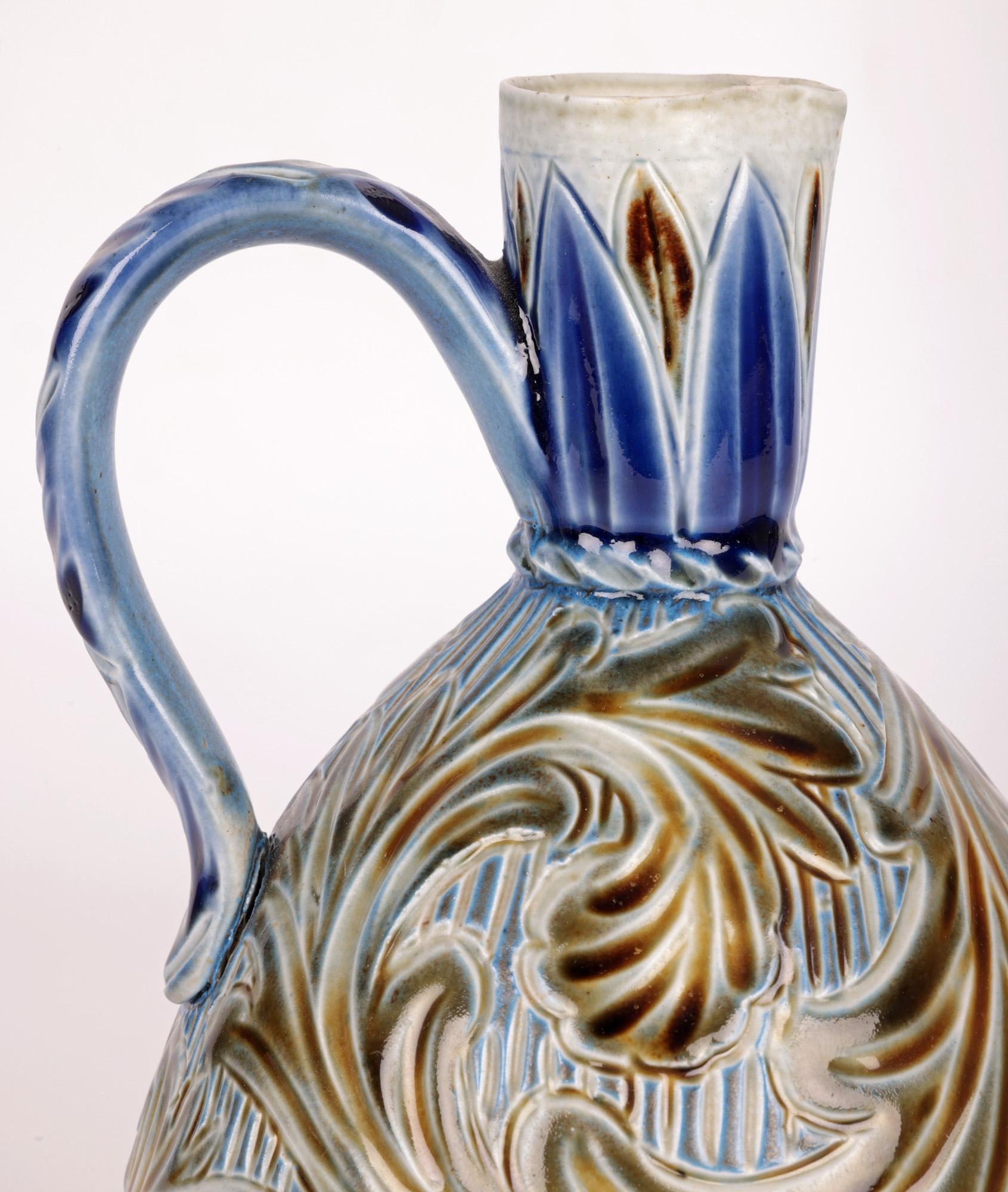 A very stylish and early Doulton Lambeth Art Pottery jug decorated with stylized scrolling leaf designs  by highly renowned artist Frank A Butler and dated 1873. The stoneware jug is of rounded bulbous shape standing on a narrow round foot and tall