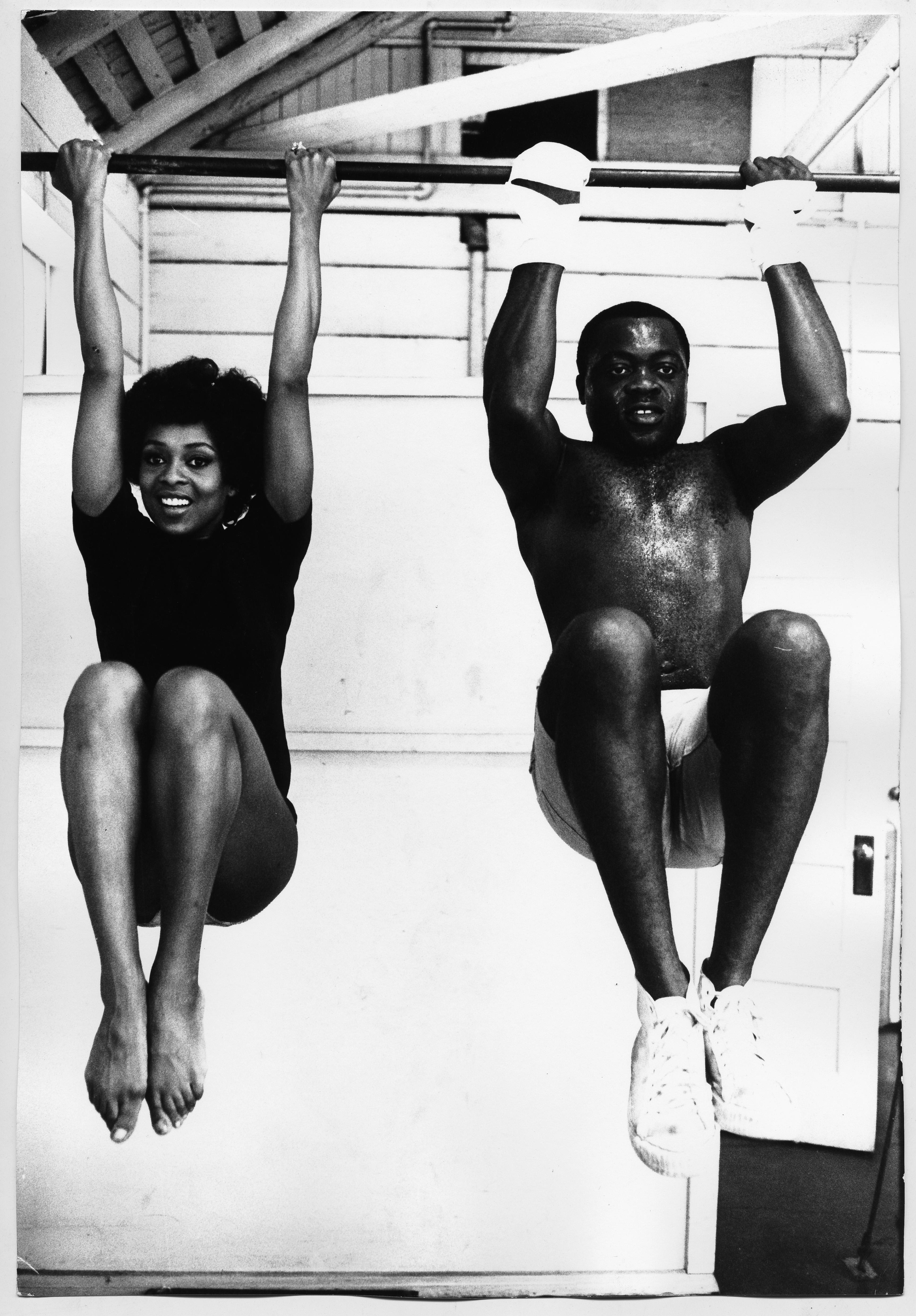 Frank D. Dandridge Black and White Photograph - Lola Falana in the gym doing pull-ups photographed by Frank Dandridge, 1969.