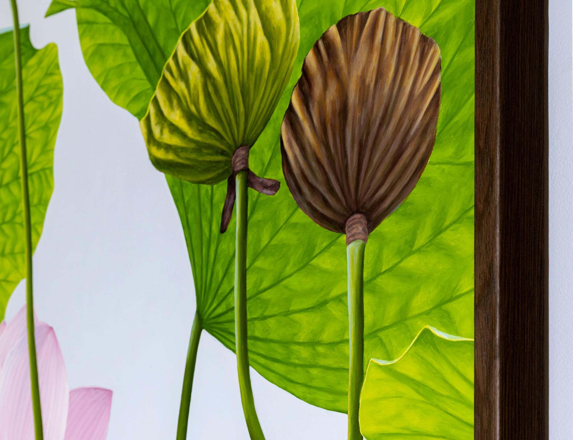Photorealist still life painting on canvas of a light pink lotus flower with brown lotus pods and green petals against a light grey background
