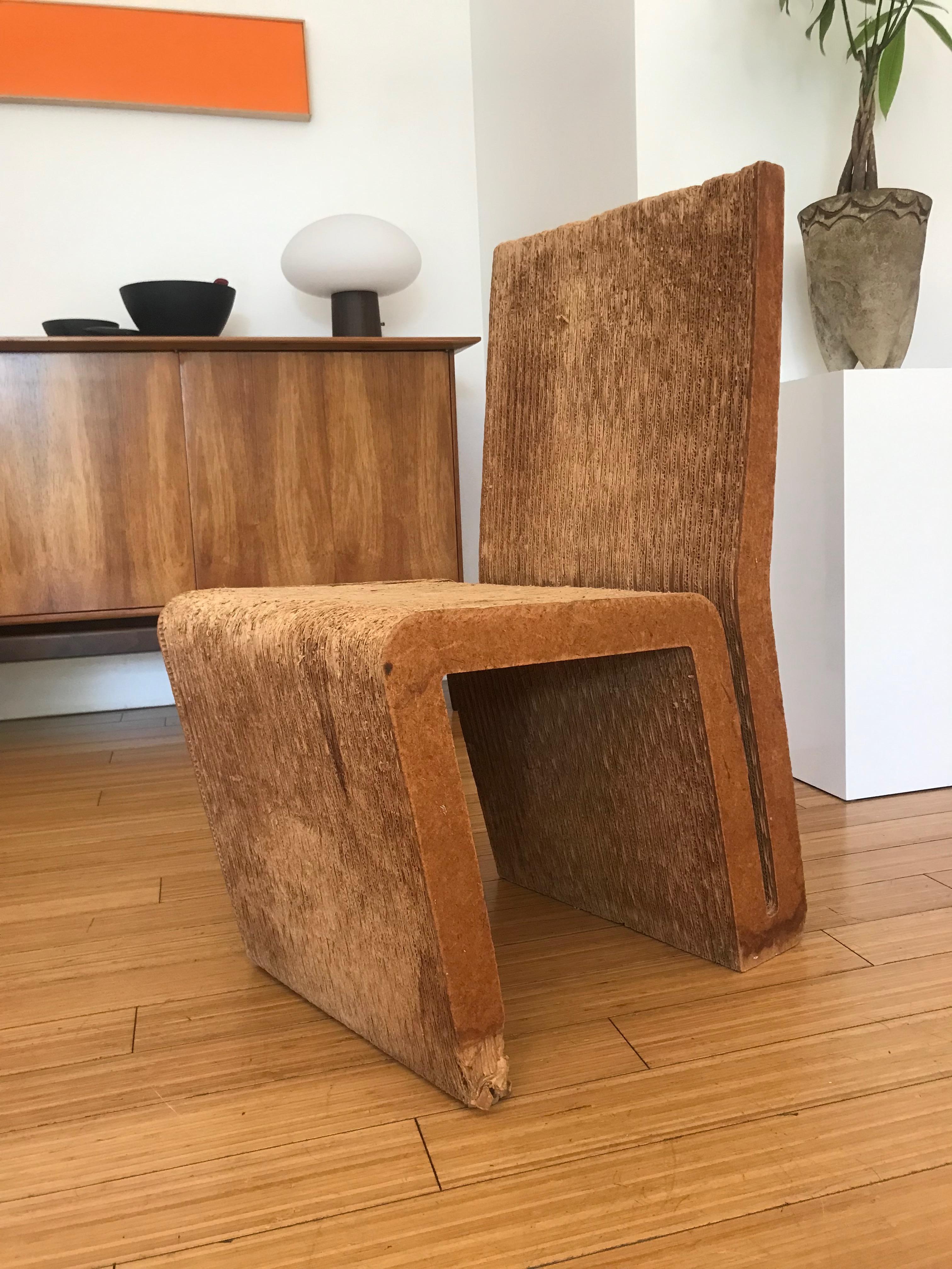 An early example of one of Frank Gehry's cardboard chairs.
Nice architectural design with a great patina and wear consistent with age and use.
It was well loved.
Despite its' apparent wear, it's solid and sturdy.
It presents well as a modernist