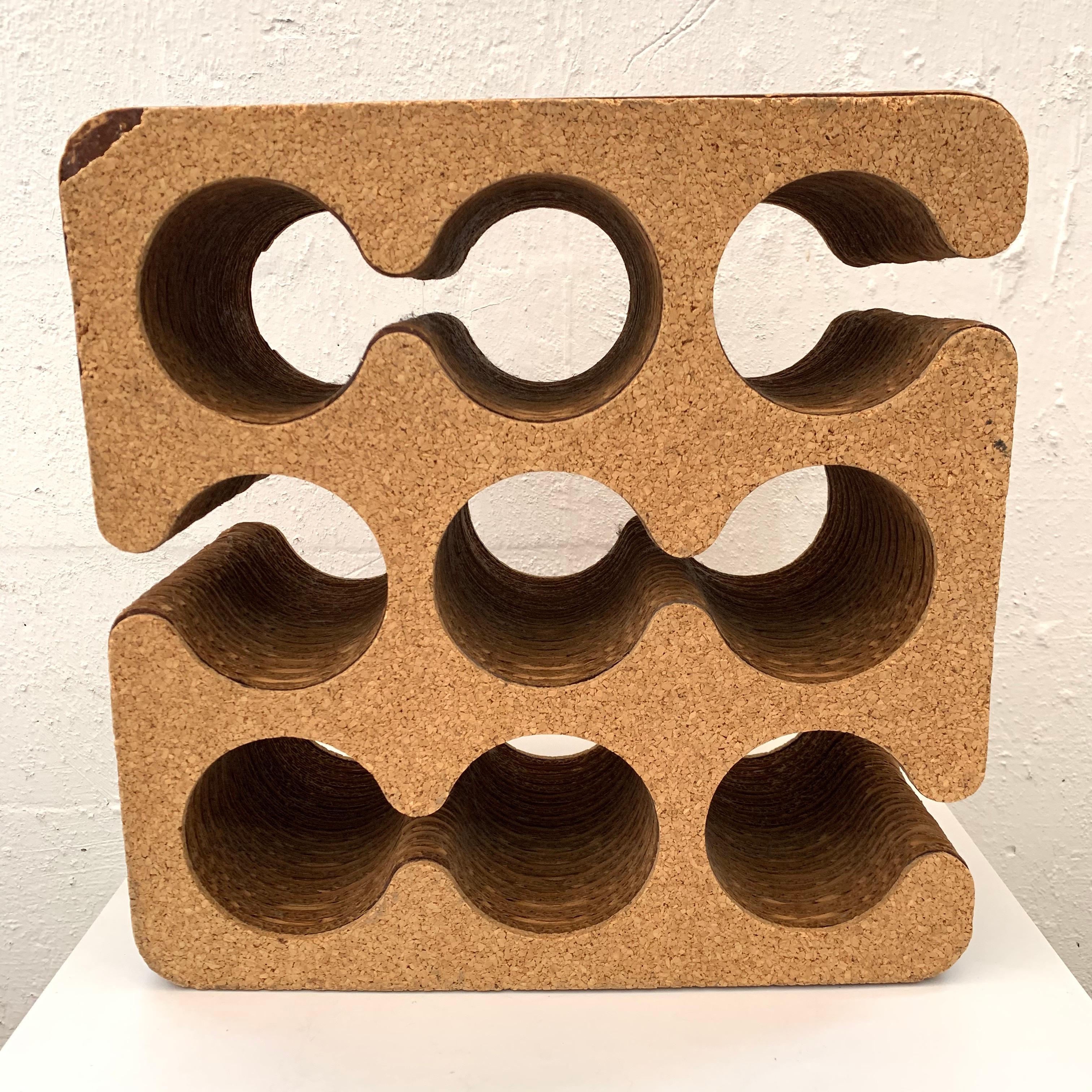 Postmodern sculptural 9 bottle wine rack of holder rendered in corrugated card board with cork exterior designed by Frank Gehry for his Easy Edges line, 1980s.