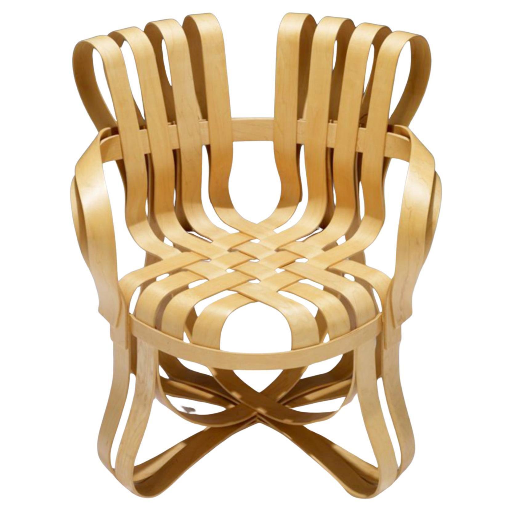 Inspired by the apple crates he had played on as a child, Pritzker Prize-winning architect Frank Gehry created the ribbon-like design of the Cross Check chair with interwoven maple strips. 
The graceful design integrates material with structure,