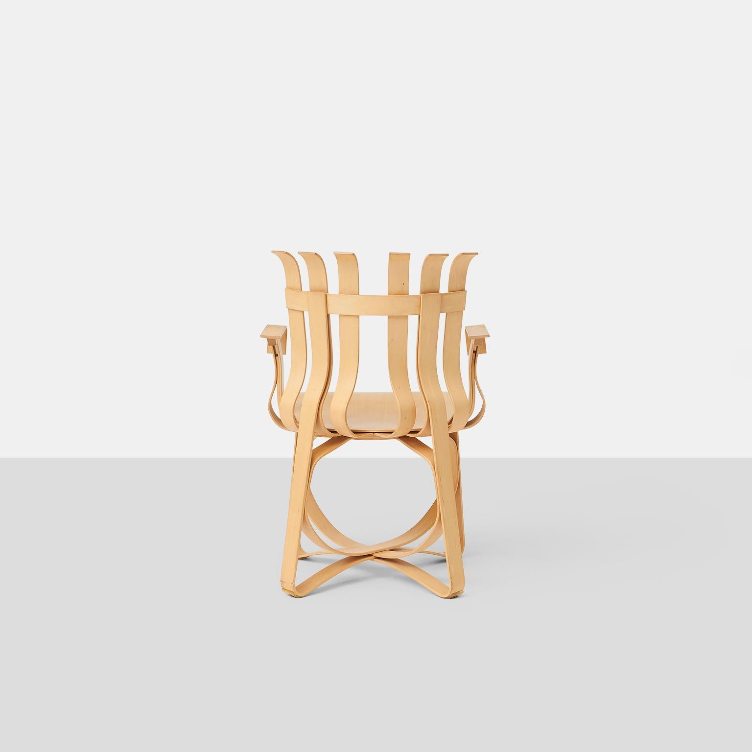 A group of dining chairs by Frank Gehry in woven maple for Knoll. Signed, dated and numbered on the underside. 
Six side chairs are available. Two arm chairs are available separately.
Sold and priced in pairs.
