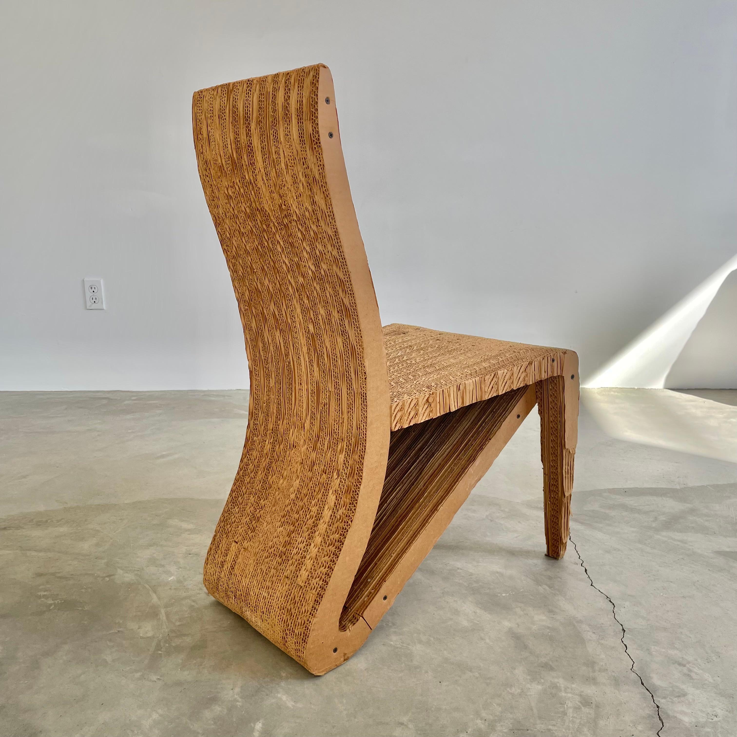 Extremely rare cardboard prototype chair for Frank Gehry from the estate of Margot Alofsin, an architect of Gehry Partners. Corrugated cardboard chair with two slender front legs and a wide loop rear base that is one solid shape with the rest of the