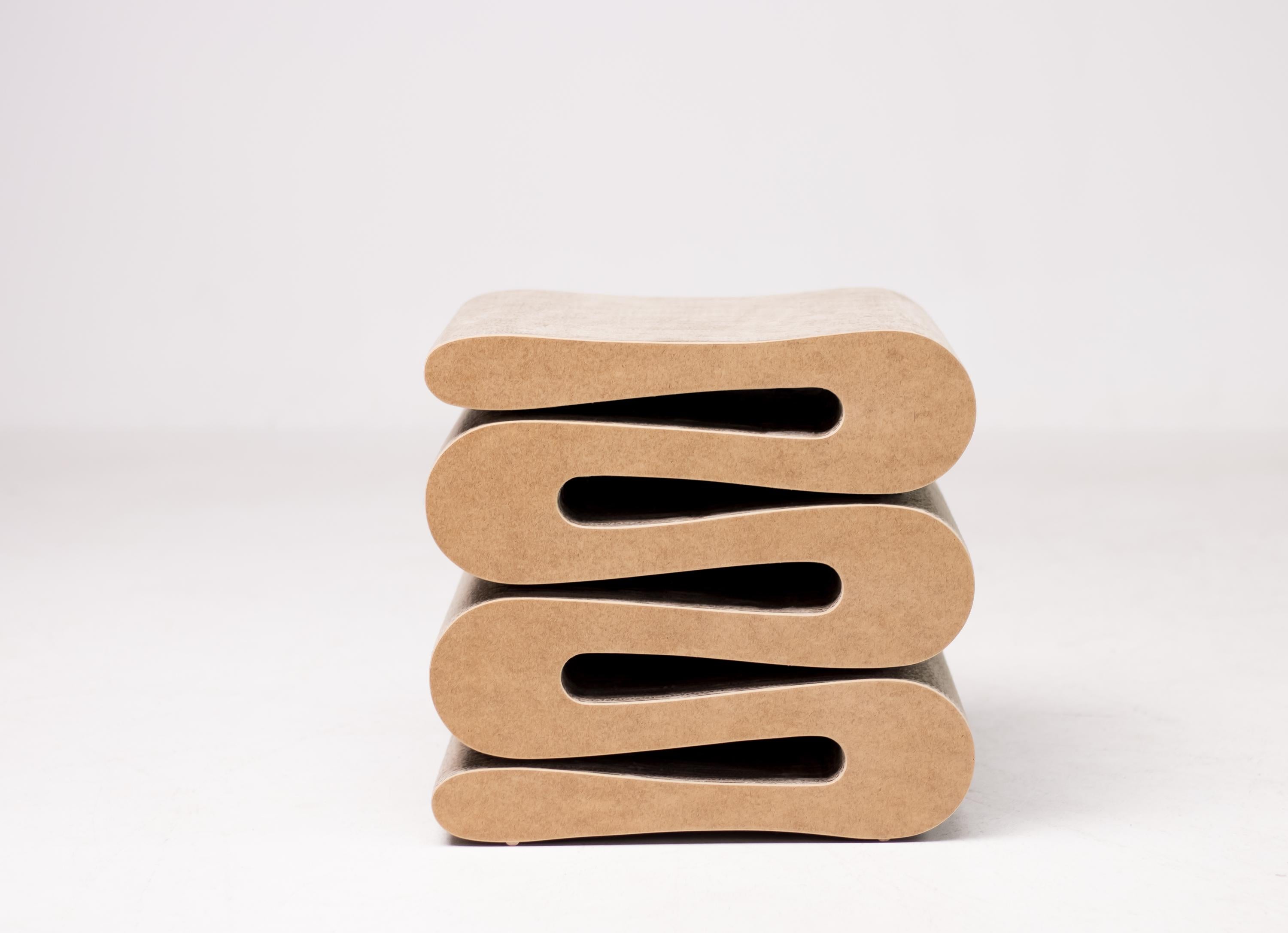 Frank Gehry Wiggle stool. Made of corrugated cardboard and hardboard to the edges. 
Labeled underneath.