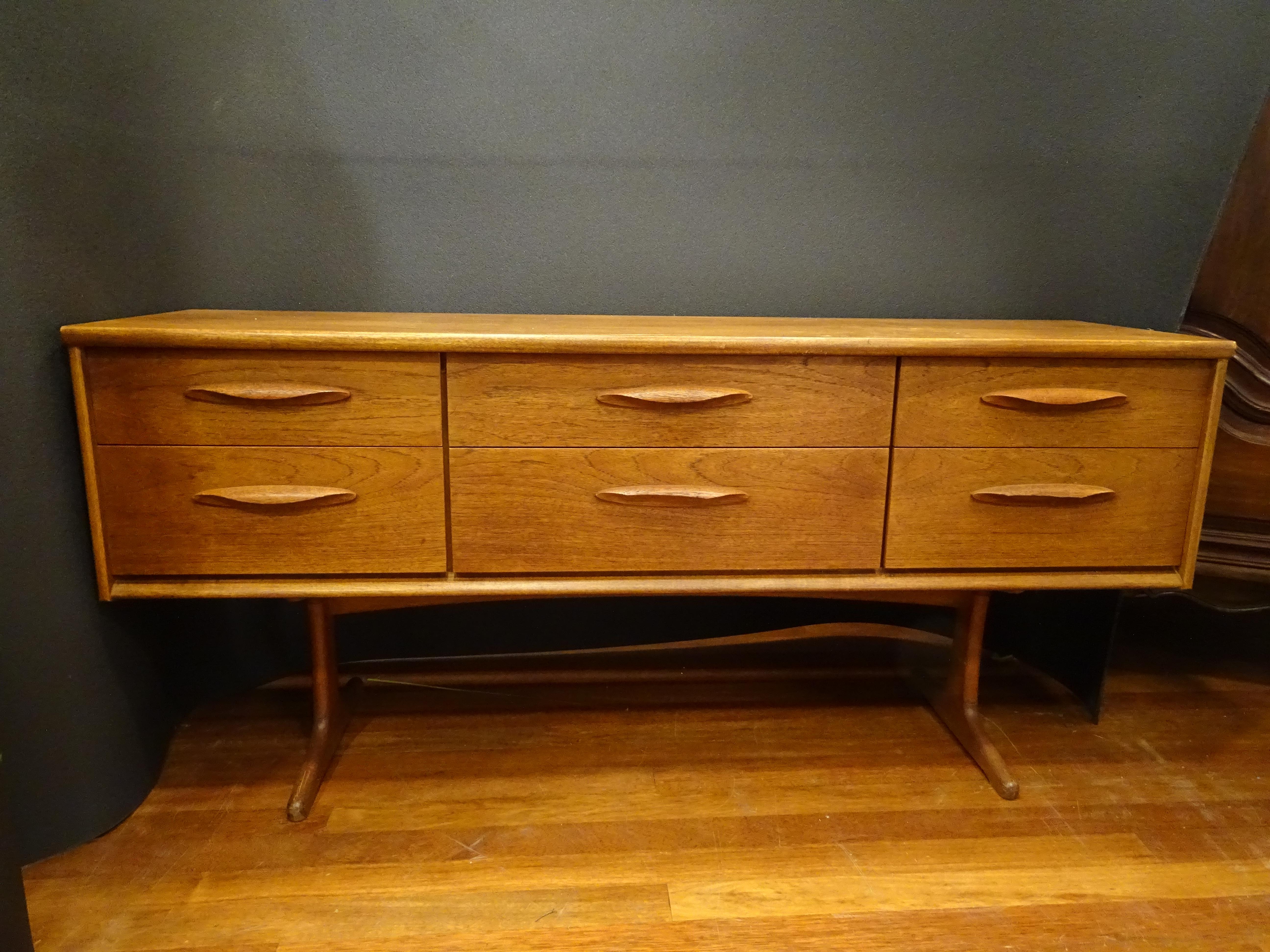 Amazing Danish design sideboard made in the 50s by Frank Guille (renowned Danish midcentury designer), it is a timeless piece, of perfect size to place in any space. The entire structure is made of teak wood of rich grain.
The main structure is