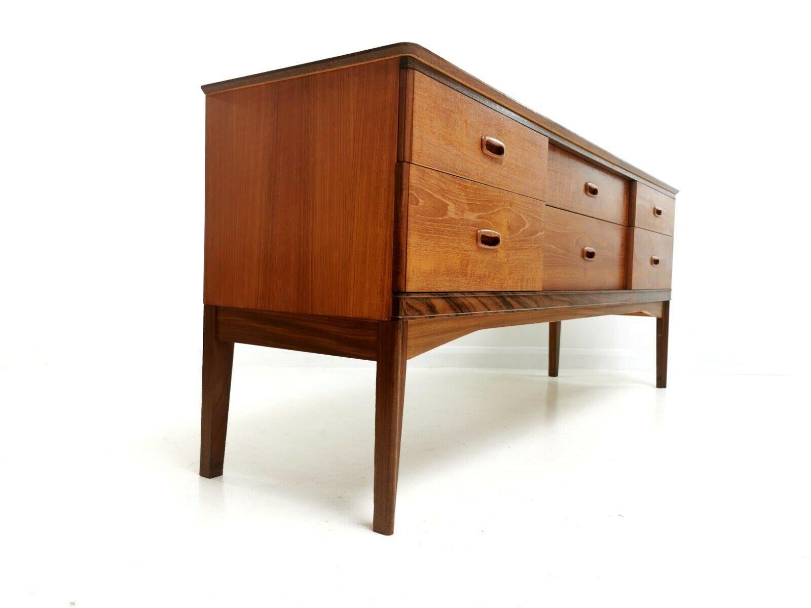 Austinsuite teak sideboard 

An Austinsuite sideboard by Frank Guille, which features six generous drawers with recessed handles. 

Danish design. Beautiful rich teak wood grain,

circa 1960s. Made in London, UK.

Dimensions (cm): 

164 W