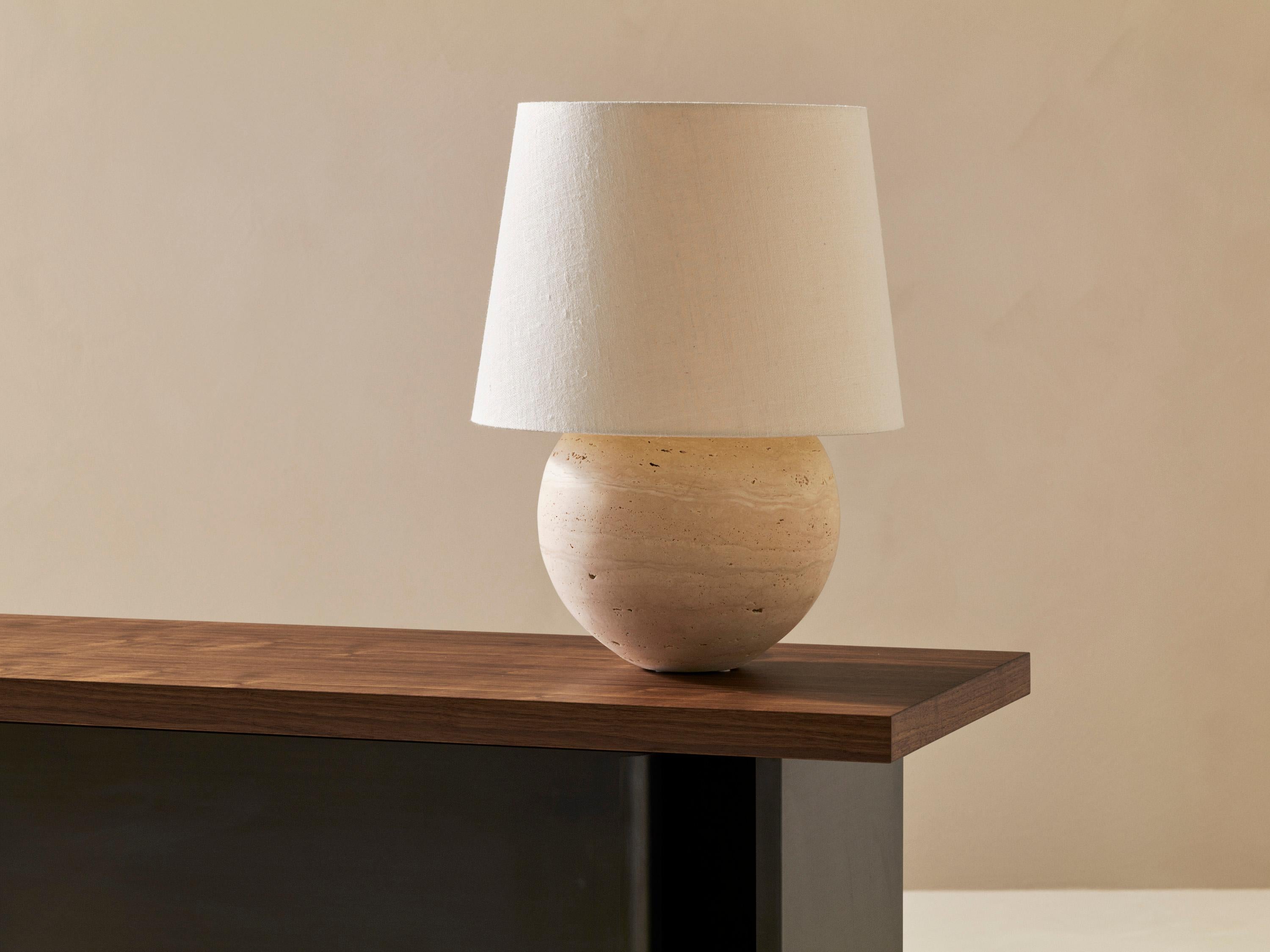 Frank L Table Lamp by Veermakers
Dimensions: D 24 x H 45 cm, Shade Ø 34.
Materials: Travertine stone / Cream textile.

About: After years of successful collaboration on luxury interior design projects, Louise Liljencrantz and KFK Cabinet Makers came