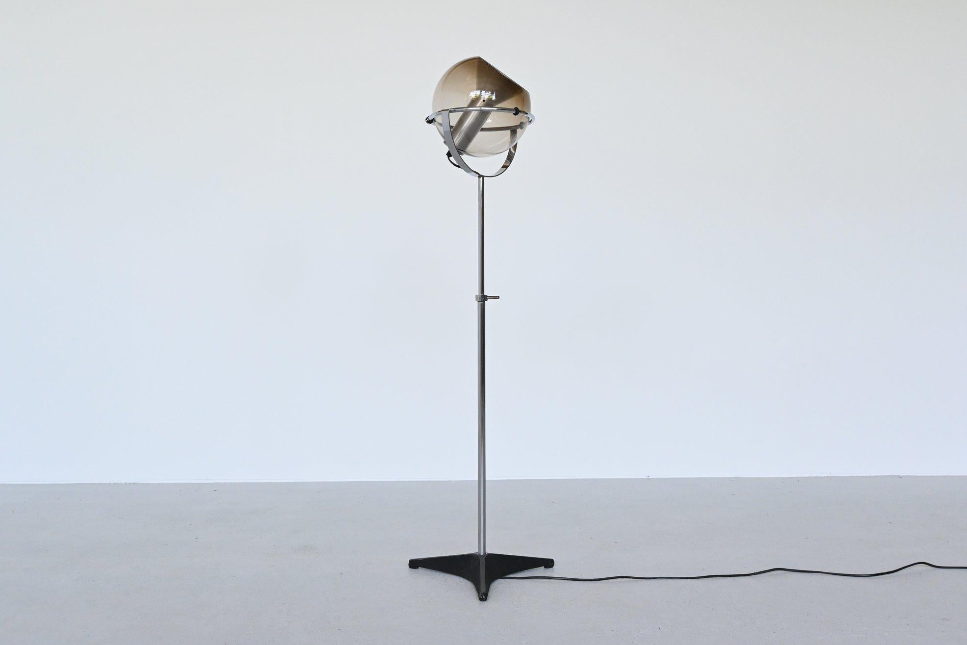 Beautiful Globe 2000 floor lamp designed by Frank Ligtelijn for RAAK Amsterdam, Netherlands, 1960. It has a light smoked glass globe supported by a chromed metal ring. Inside the globe is an aluminum reflector. Standing on a chromed metal rod and
