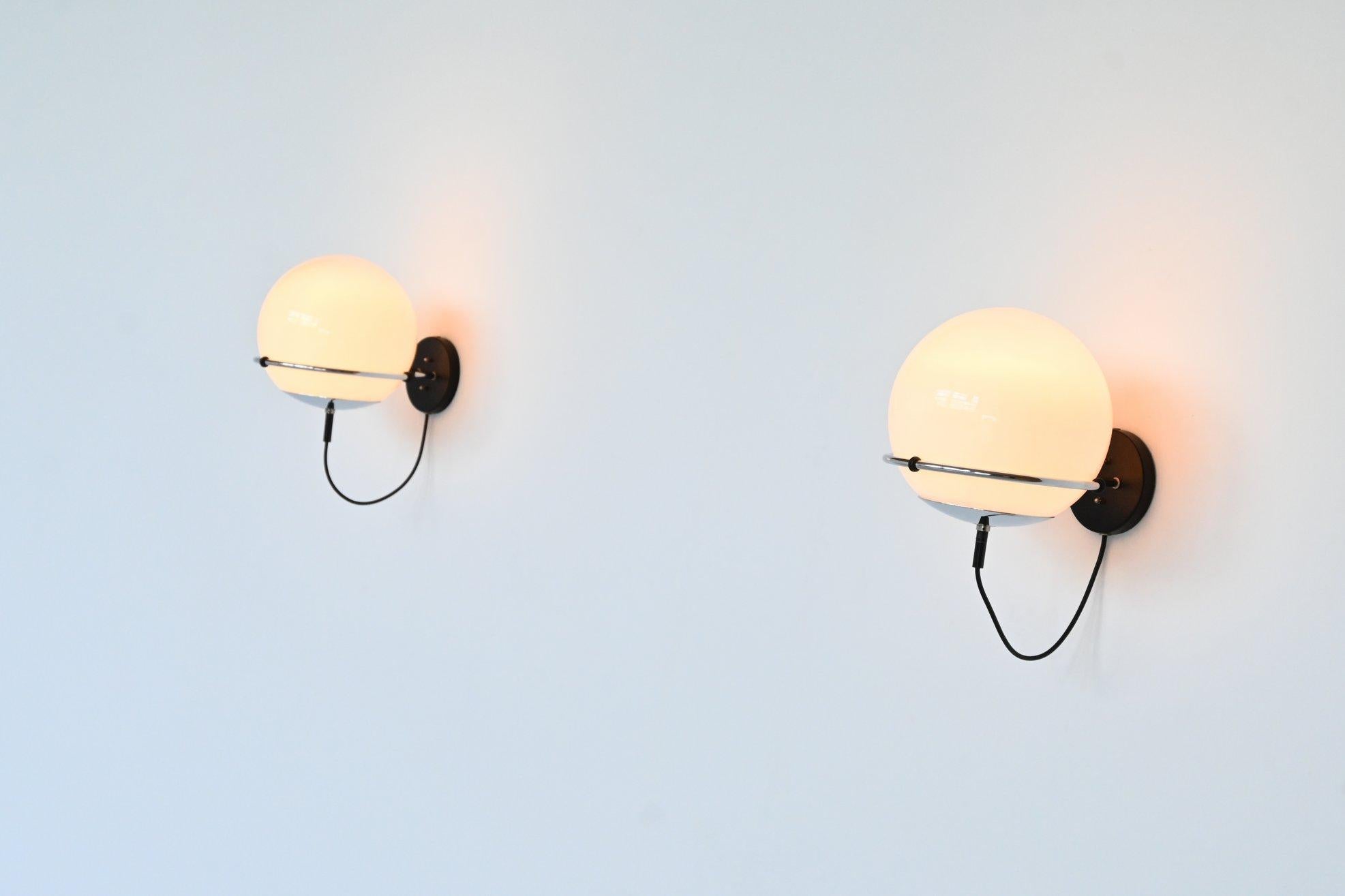 Beautiful pair of sconces lamps model C-1751 Morning Haze designed by Frank Ligtelijn and manufactured by RAAK, The Netherlands 1970. These lamps have a chrome plated ring with a black lacquered wall plate and a glass ball that goes from white glass