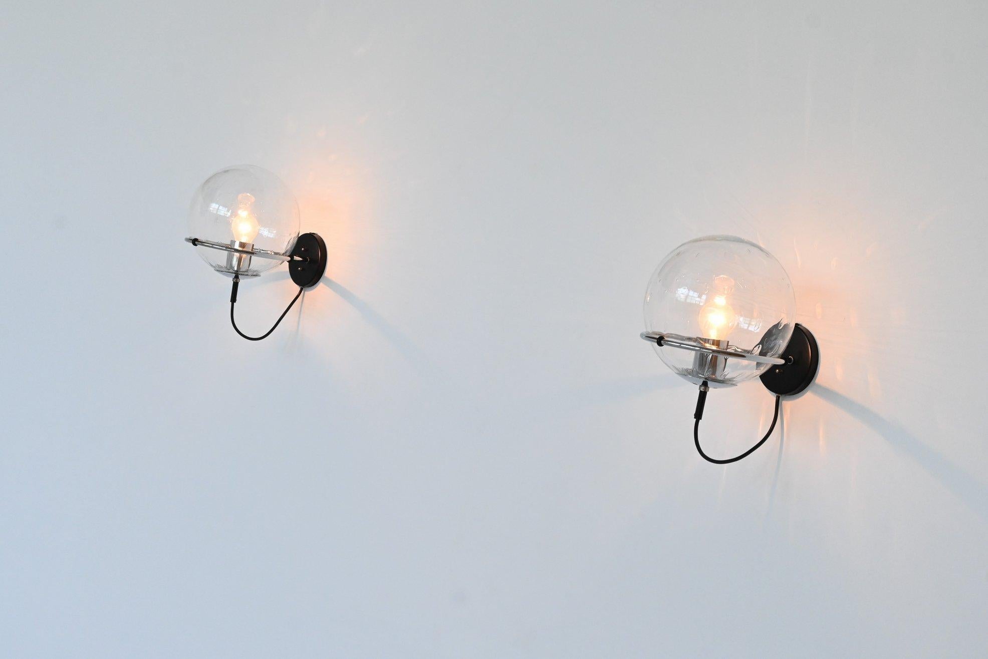 Beautiful pair of sconces lamps model C-1725 Raindrop designed by Frank Ligtelijn and manufactured by RAAK, The Netherlands 1970. These lamps have a chrome plated ring with a black lacquered wall plate and the globes have raindrops look glass with