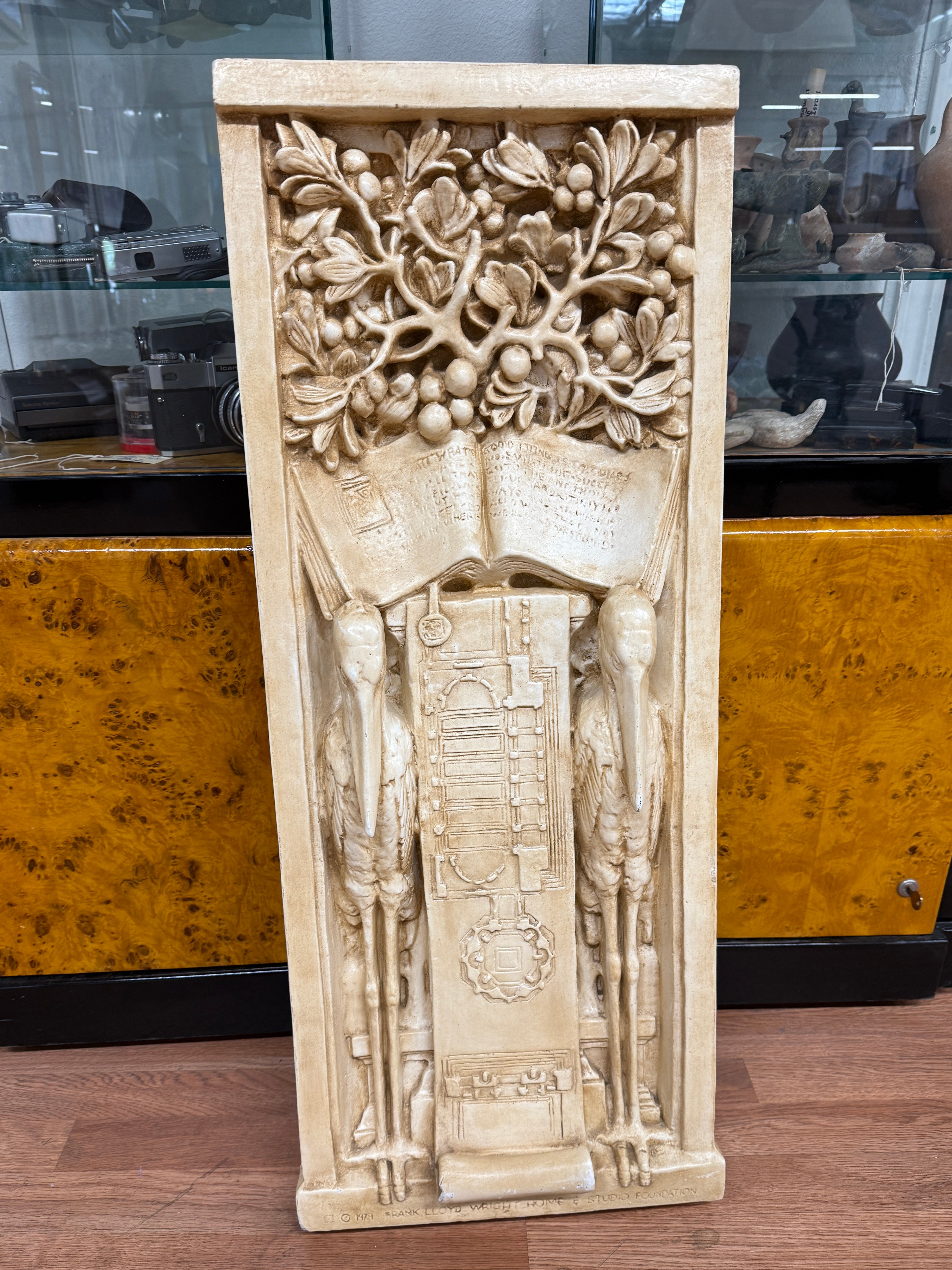 Licensed and manufactured by the Frank Lloyd Wright Home & Studio Foundation in 1979, this large Plaster Bas-Relief Plaque is an exact replica of the original, which adorned the entrance of Frank Lloyd Wright’s studio in Oak Park, Illinois. This