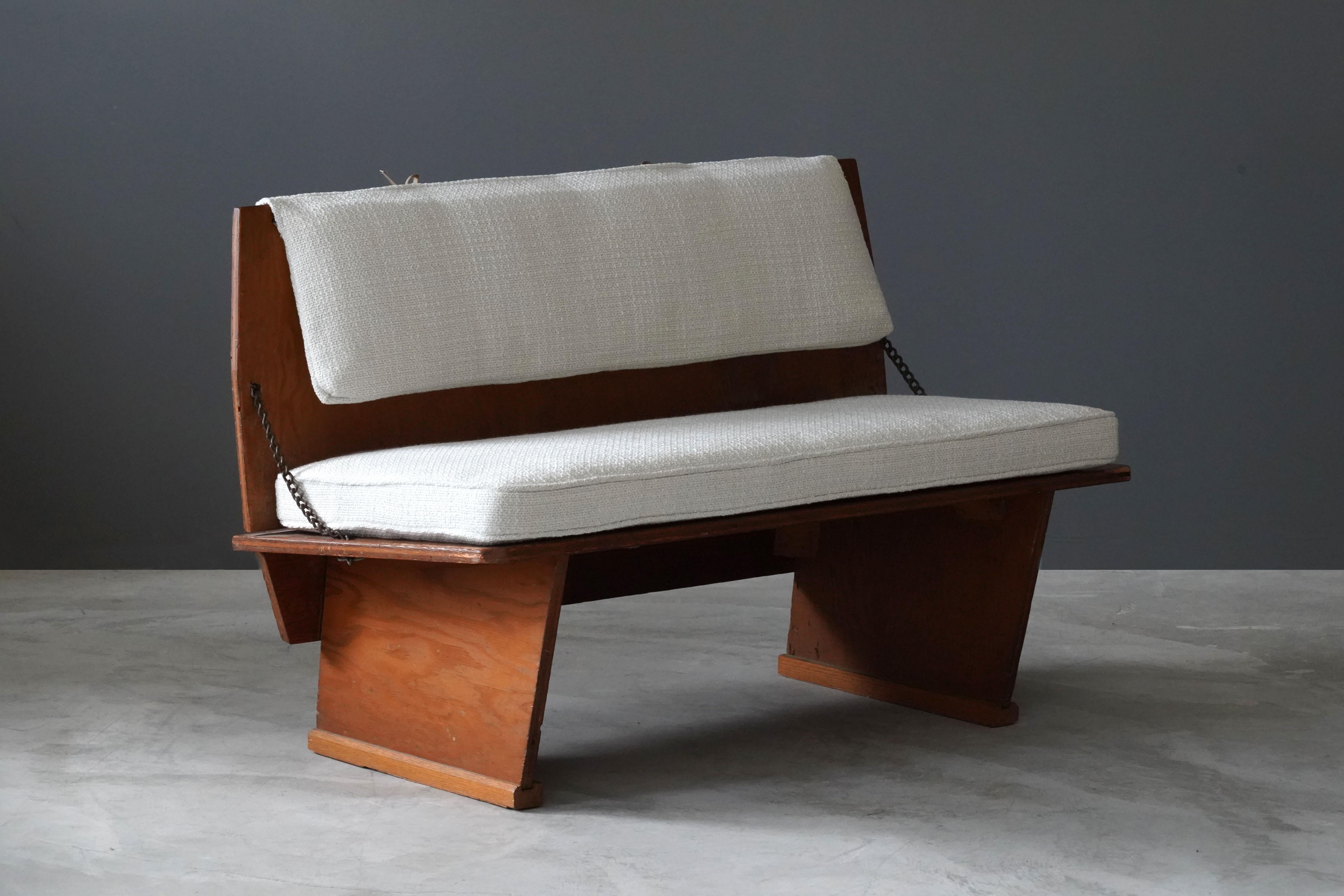 A rare bench / loveseat / settee designed by Frank Lloyd Wright produced by his Taliesin studio. Produced in limited numbers for Lloyd Wright's famous Unitarian Church in 1951. Marked.

Present bench is the rarer variation of two model benches