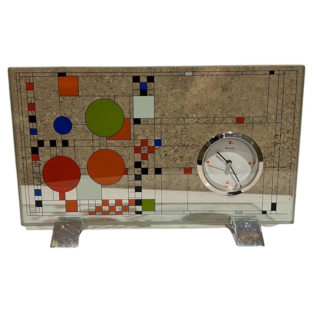 Bulova (B7757) with Frank Lloyd Wright Coonley Playhouse Glass Desk Clock.
Chrome supports, Polished chrome metal bezel.
Adapted from colored windows designed by Frank Lloyd Wright for Coonley Playhouse, Riverside, Illinois
5.75 tall x 9 w x