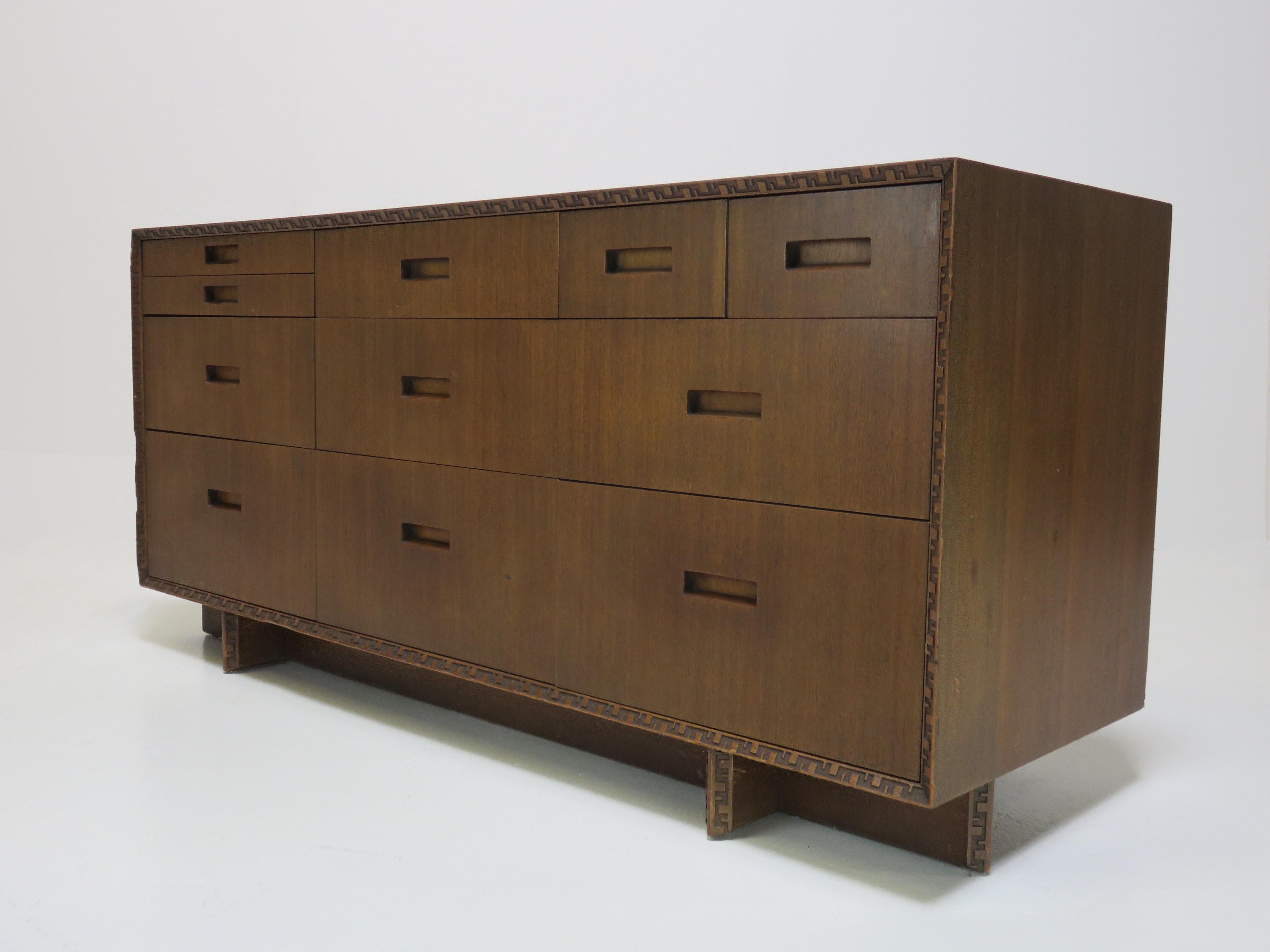 An eleven-drawer credenza by Frank Lloyd Wright for Heritage Henredon. Carved geometric banding and Taliesin design. Makers stamp.
 