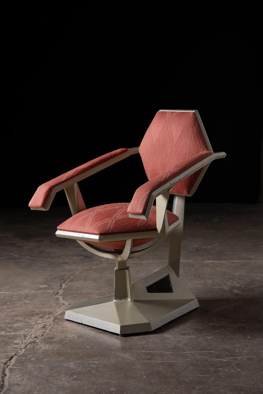 One of only forty examples ever created, this slant arm chair was designed in 1956 by Frank Lloyd Wright for the Price Tower and is often referred to as the 