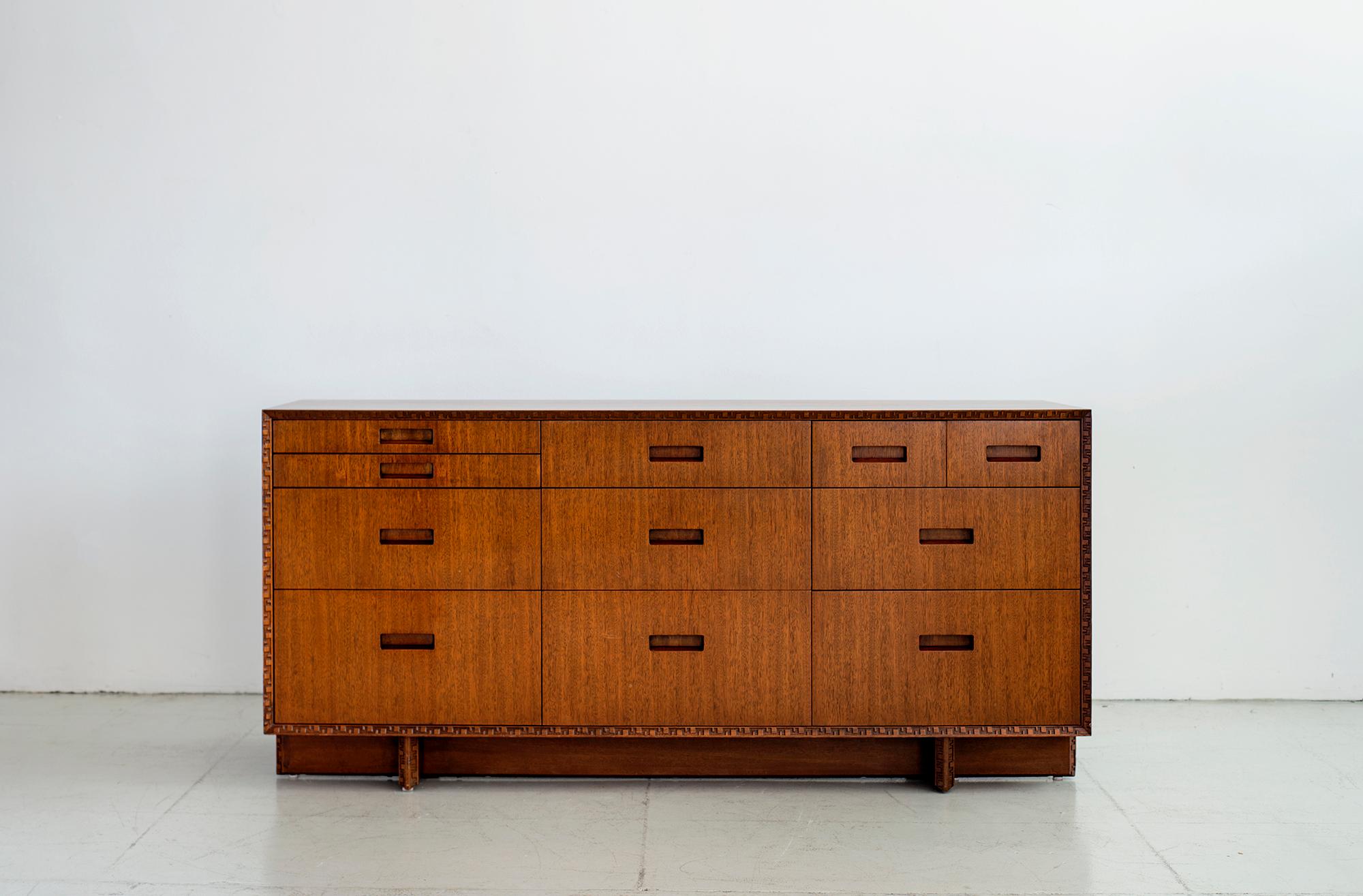 Beautiful dresser by Frank Lloyd Wright manufactured by Heritage Henredon. Distinct carvings from the Taliesin line which was named after Frank Lloyd Wright's home in Spring Green, Wisconsin. Signed by FLW and beautiful refinished.
 