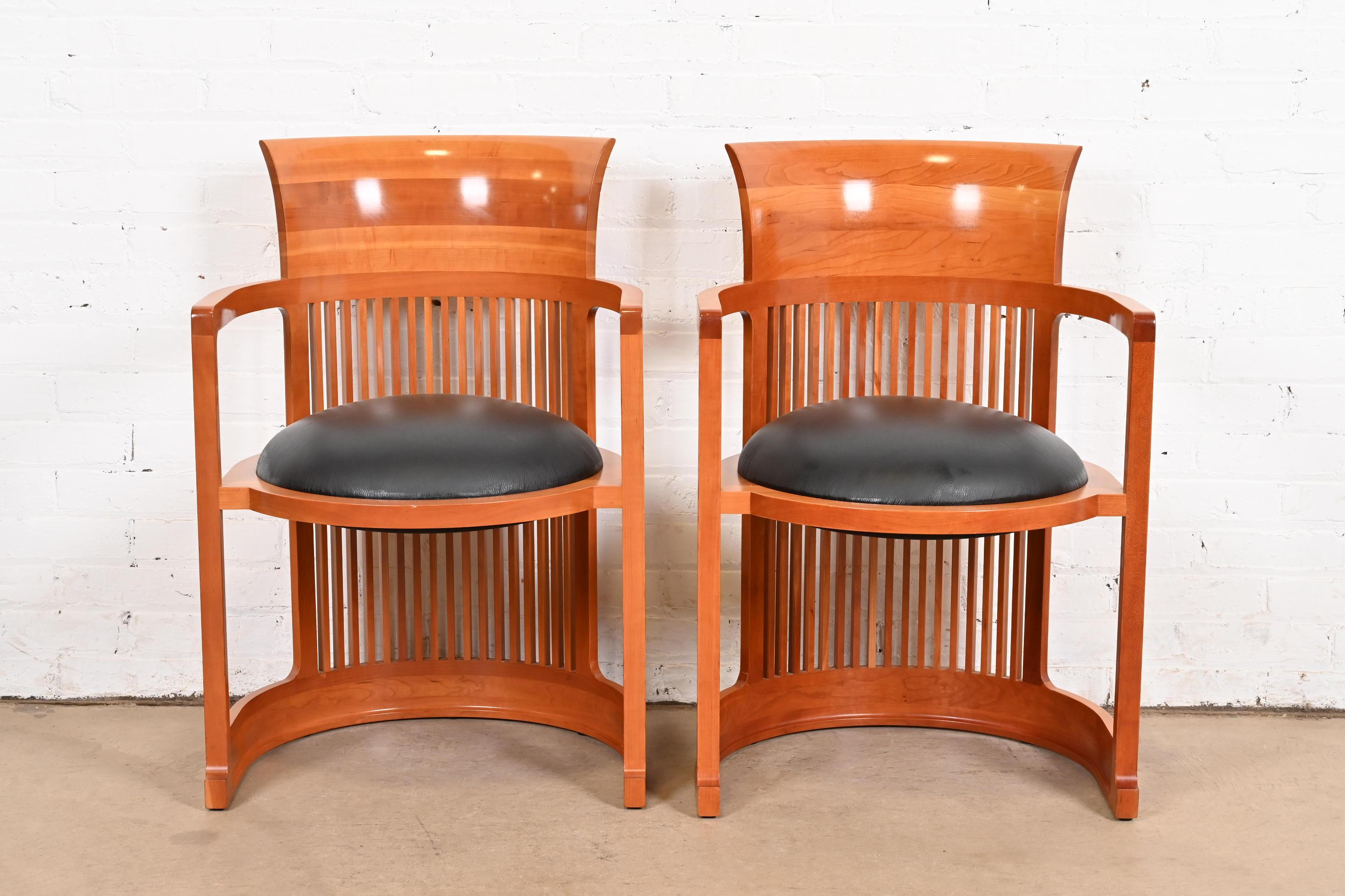 An exceptional pair of Arts & Crafts or Prairie style barrel chairs

By Frank Lloyd Wright for Cassina

Italy, 1986 (originally designed in 1903 for the Martin House in Buffalo)

Carved cherry wood, with black leather upholstered seats.

Measures: