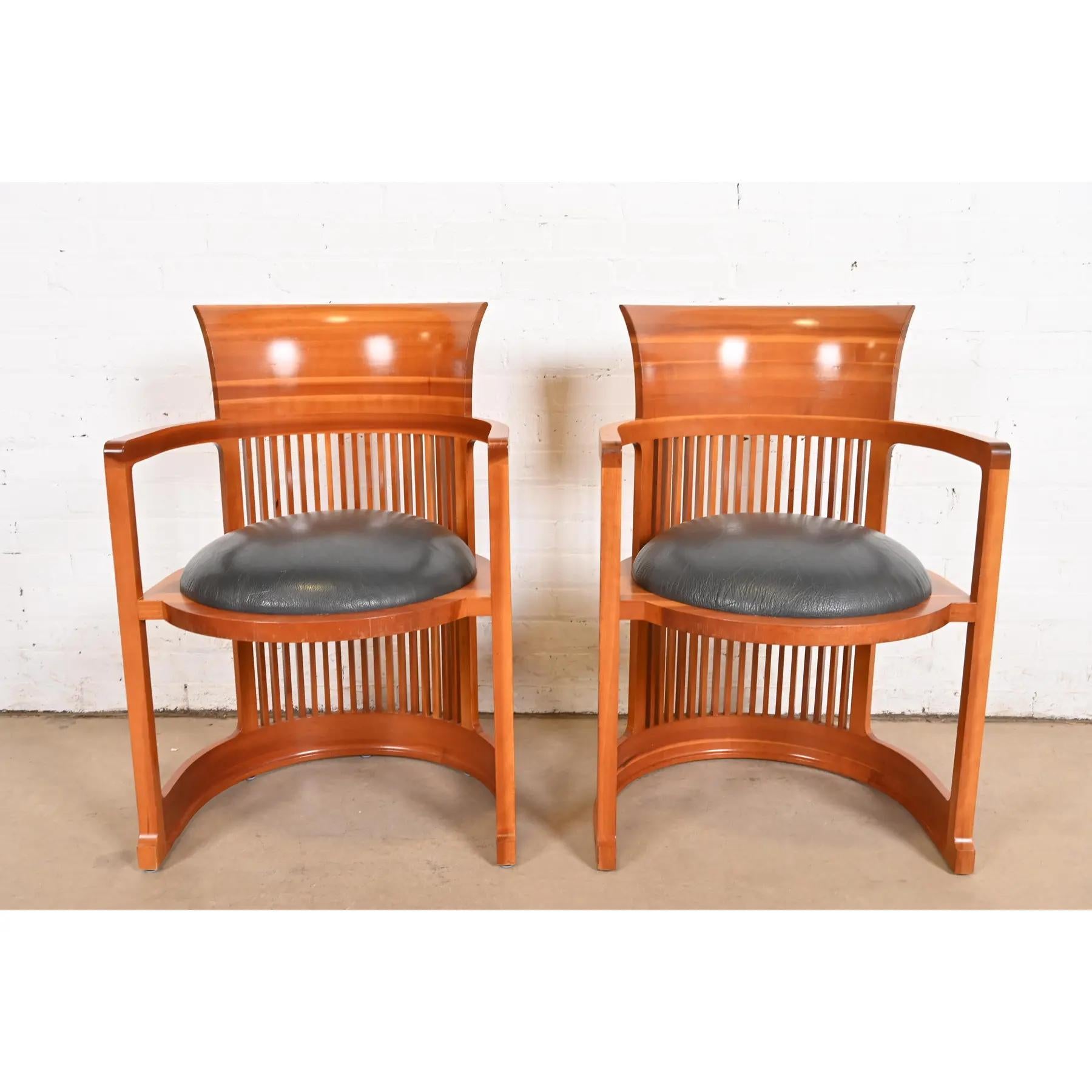 An exceptional pair of Arts & Crafts or Prairie style barrel chairs

By Frank Lloyd Wright for Cassina

Italy, 1986 (originally designed in 1903 for the Martin House in Buffalo)

Carved cherry wood, with leather upholstered seats.

Each measures: