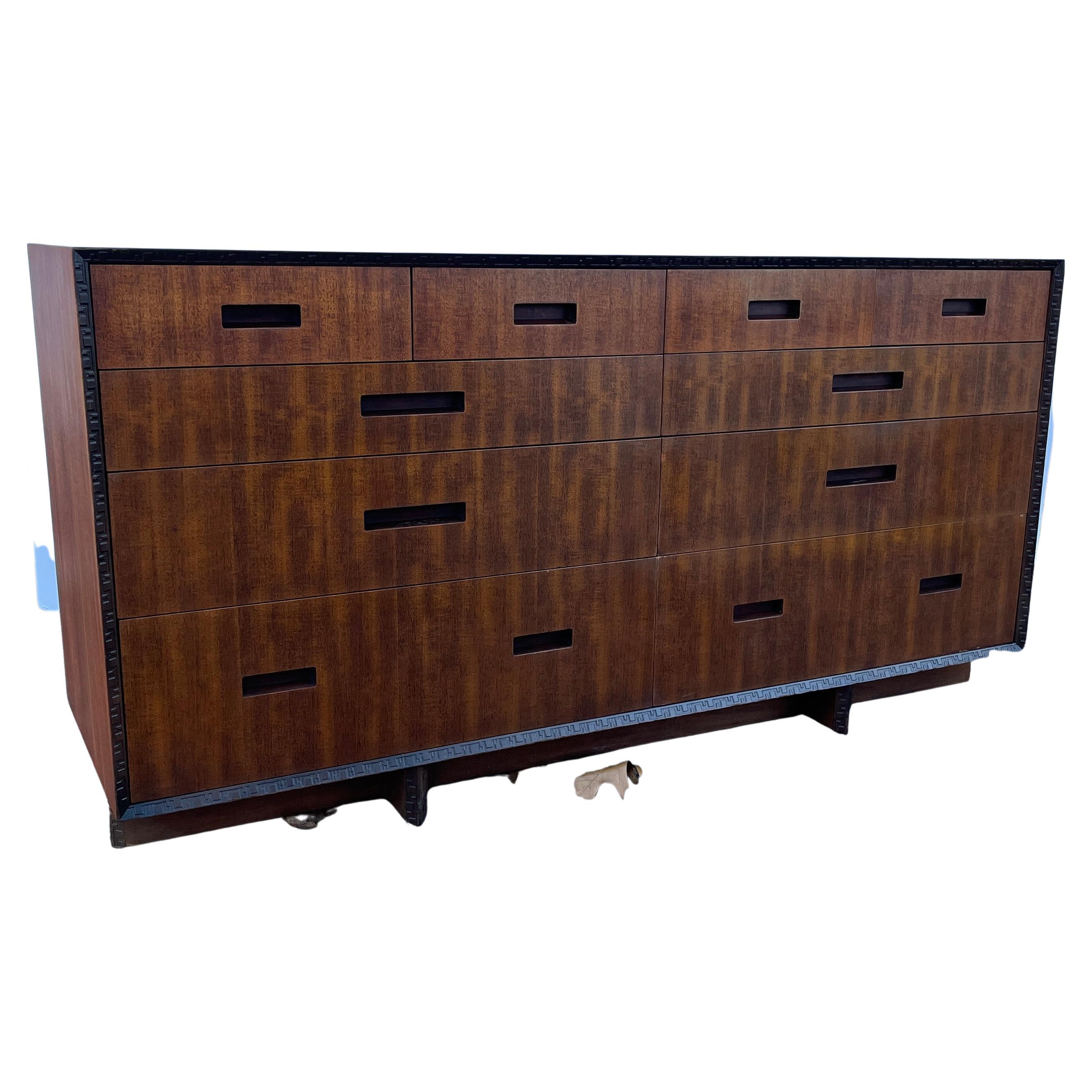 A Mid-Century Modern gorgeous twelve-drawer mahogany dresser or credenza by Frank Lloyd Wright for Heritage-Henredon furniture collection. Carved geometric banding and 