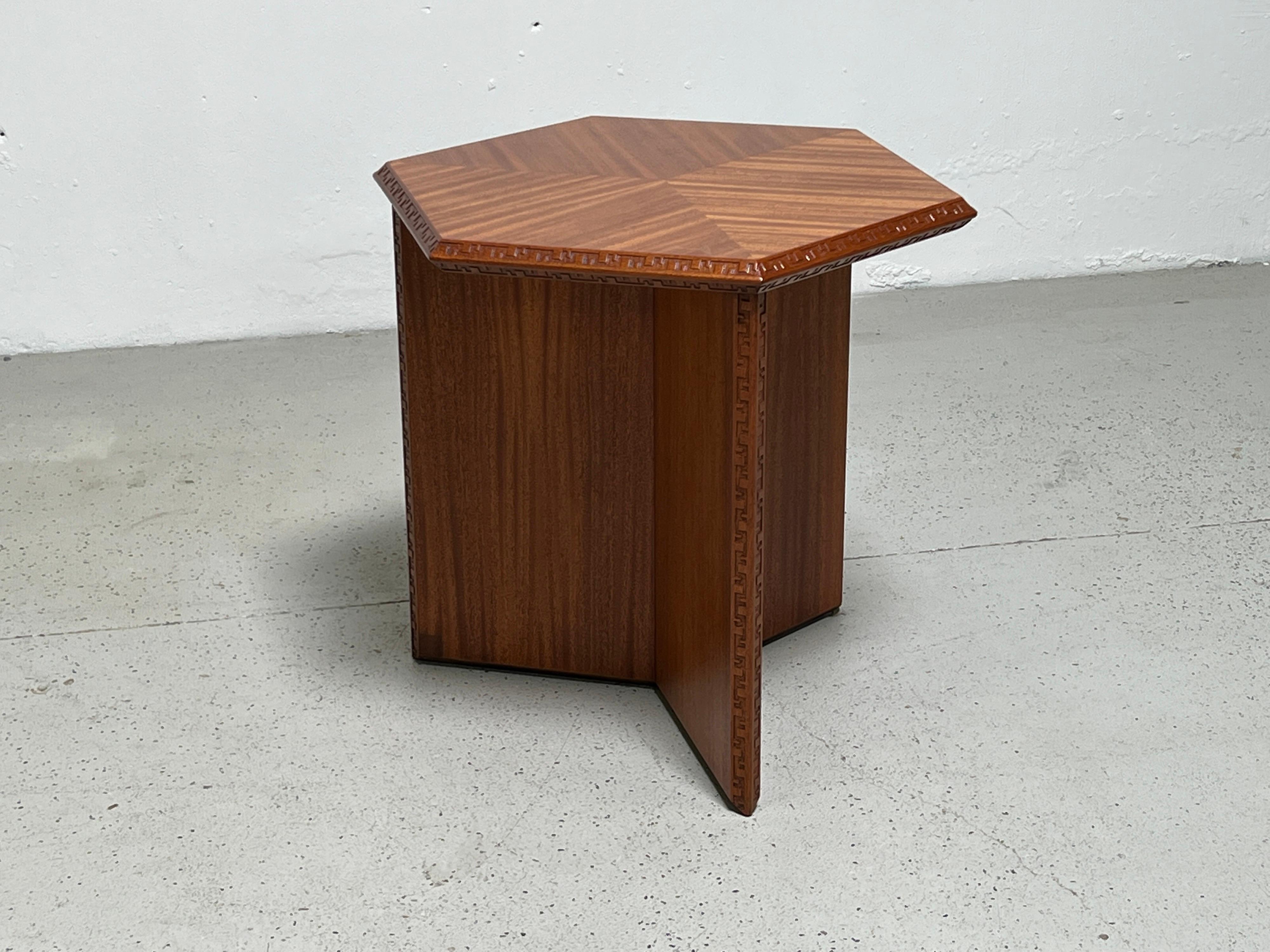 A mahogany hexagonal lamp table designed by Frank Lloyd Wright for Henredon. Smaller version available separately.