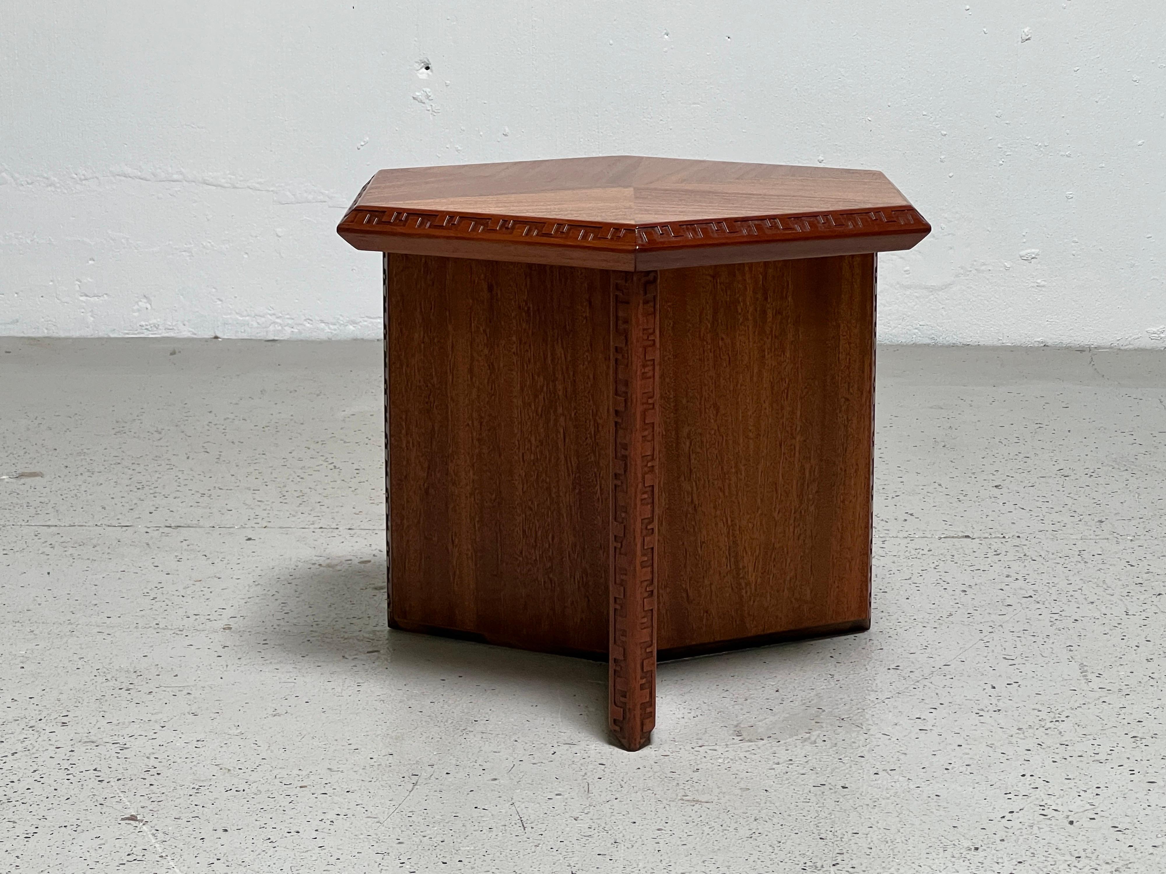 A mahogany hexagonal side table designed by Frank Lloyd Wright for Henredon. Larger version available separately.