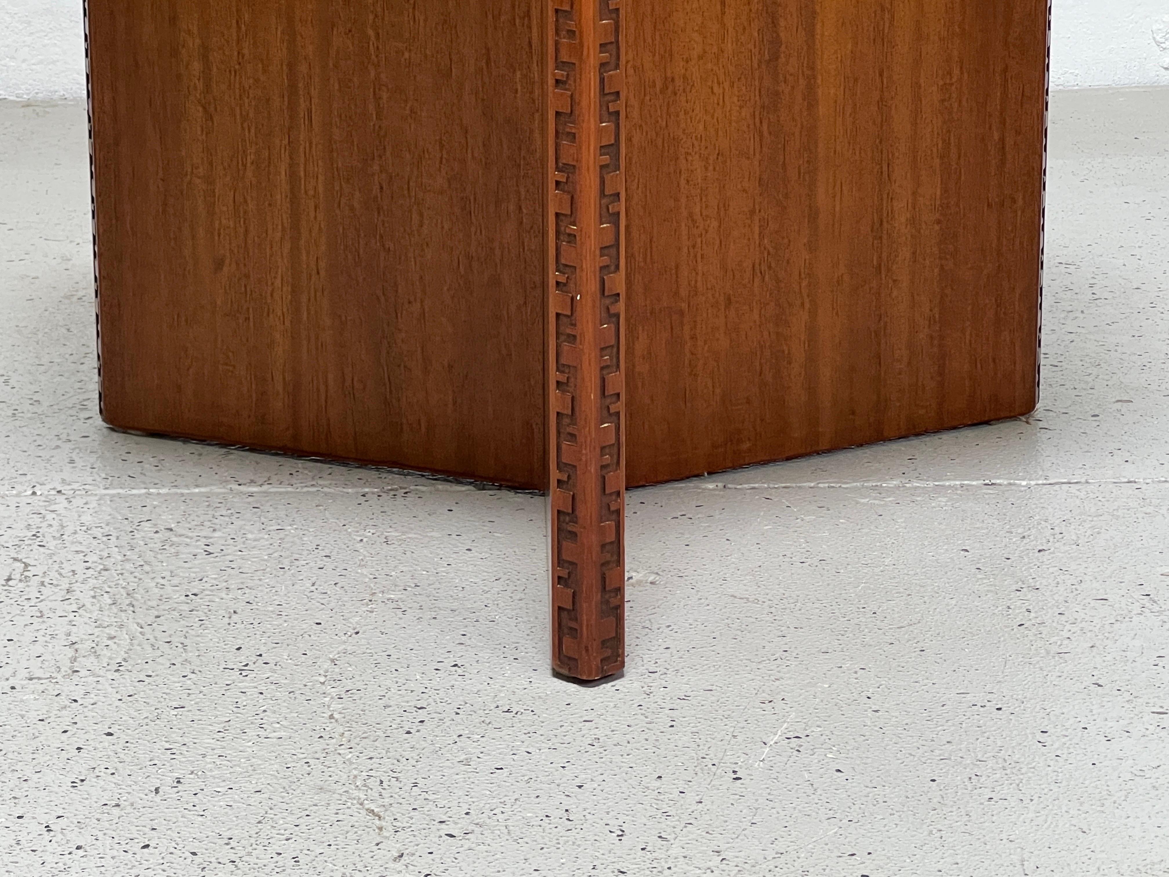 A mahogany hexagonal lamp table designed by Frank Lloyd Wright for Henredon.