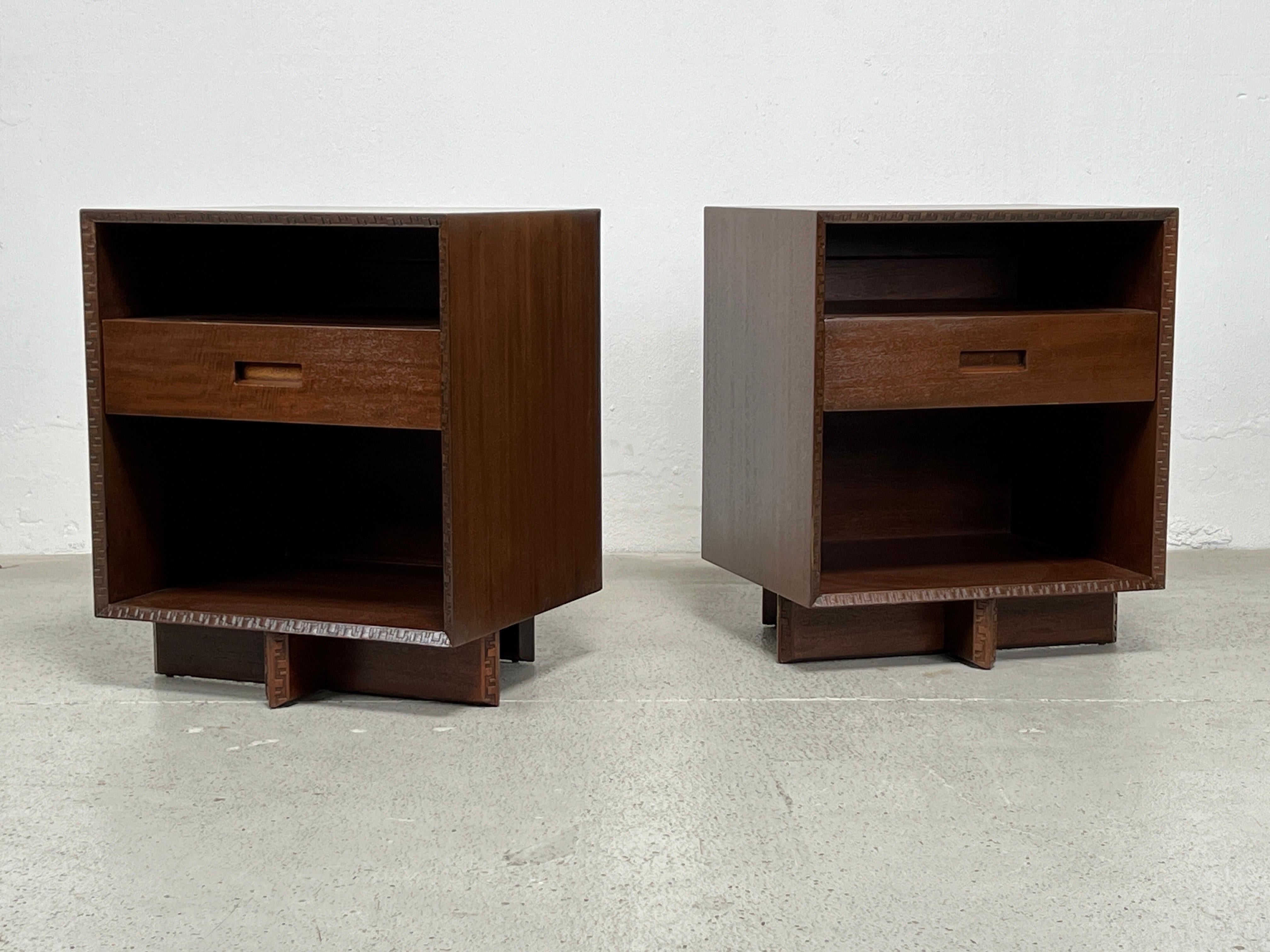 A pair of mahogany bedside tables designed by Frank Lloyd Wright for Henredon.