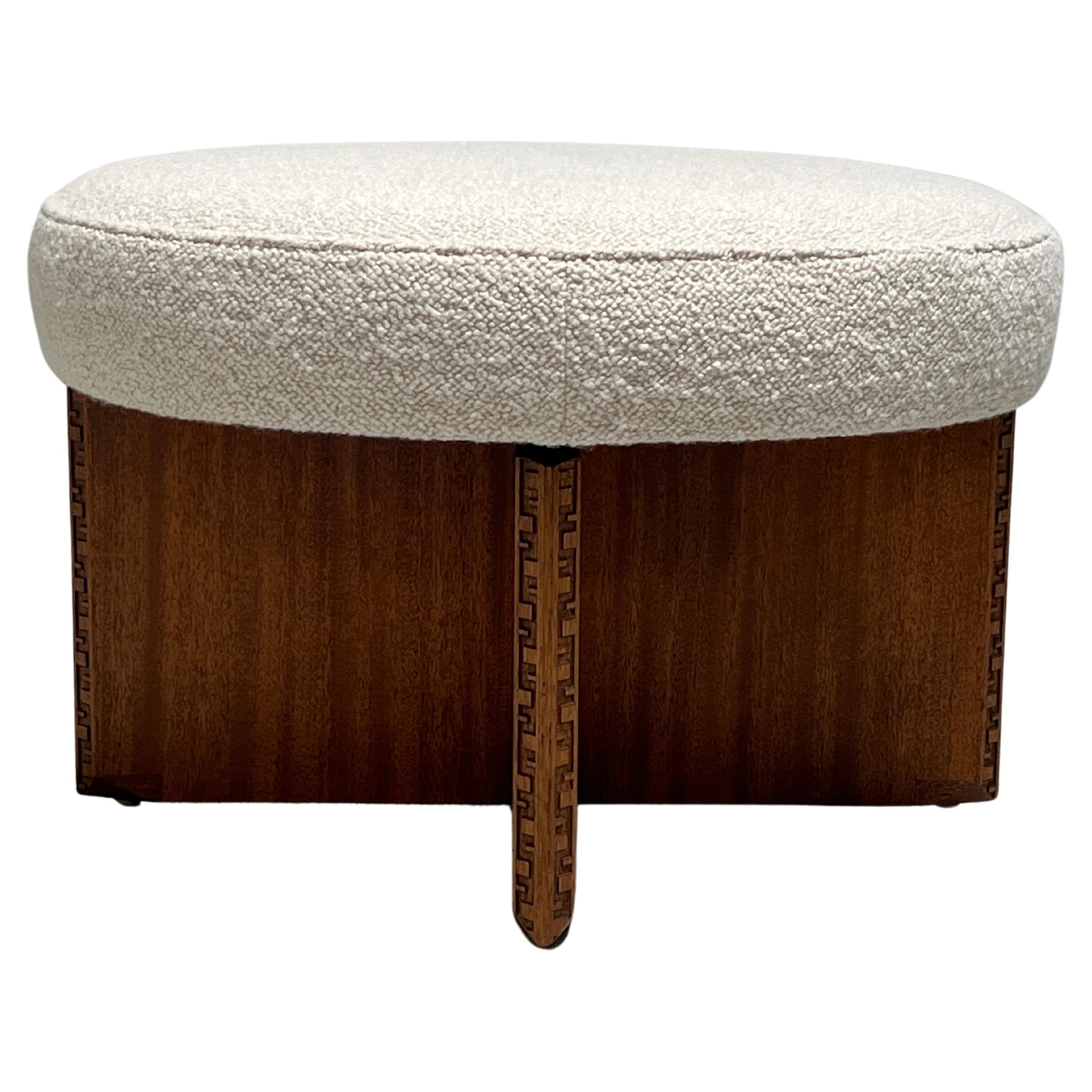 A mahogany rotating ottoman with upholstered top. Designed by Frank Lloyd Wright for Henredon. 
Reupholstered in Holly Hunt fabric.