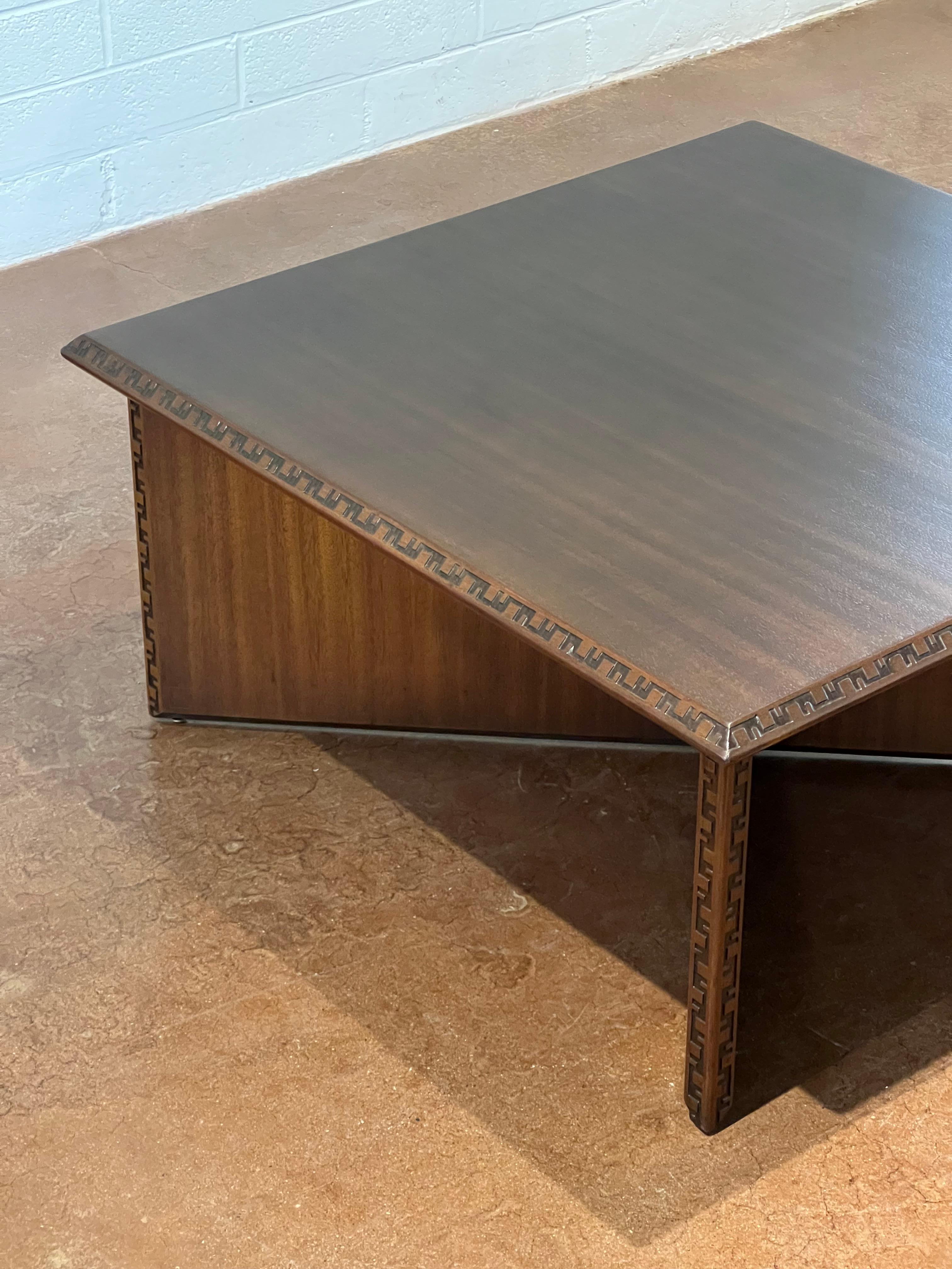 Part of the Taliesin collection that Frank Lloyd Wright designed for Henredon, this mahogany coffee table is a timeless piece. 