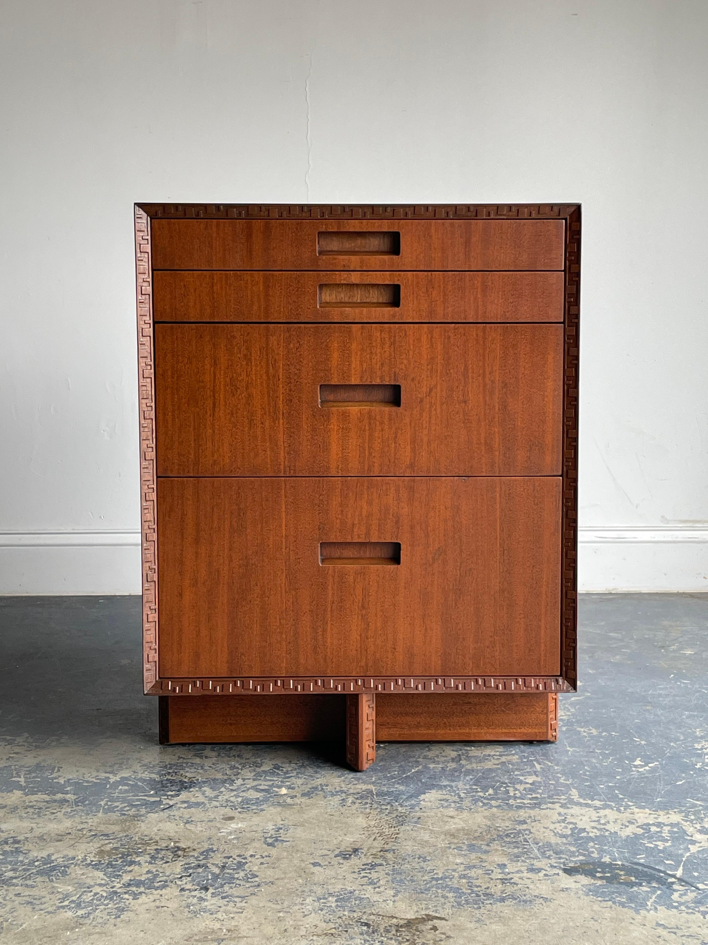A four drawer versatile chest designed by Frank Lloyd Wright. Features the iconic taliesin border. Can be used as a small chest, nightstands, end table, etc. Accompanying dresser which matches in height and depth also available, as well as a pair of