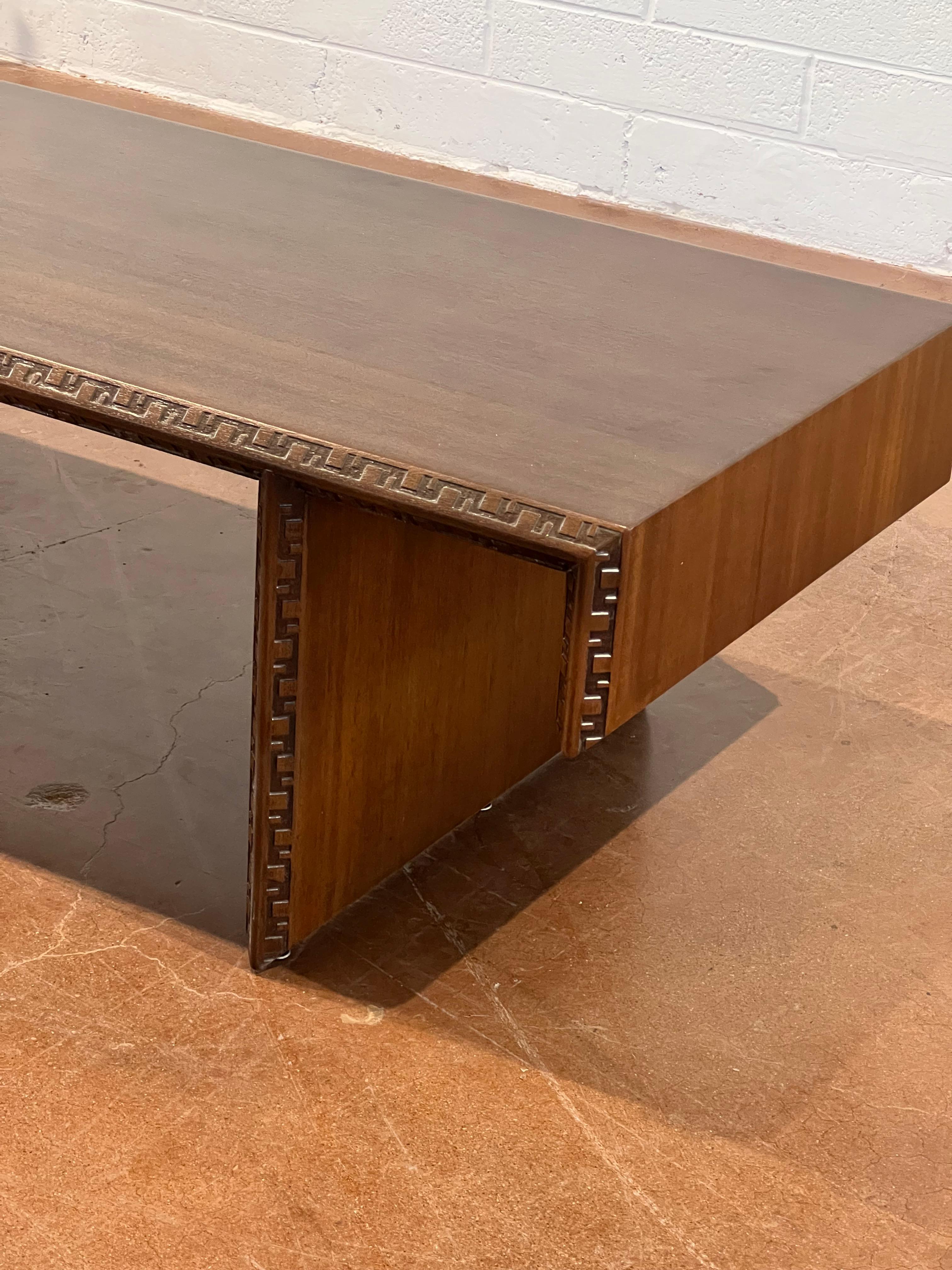 An exquisite mahogany waterfall style coffee table by Frank Lloyd Wright for Henredon. 
