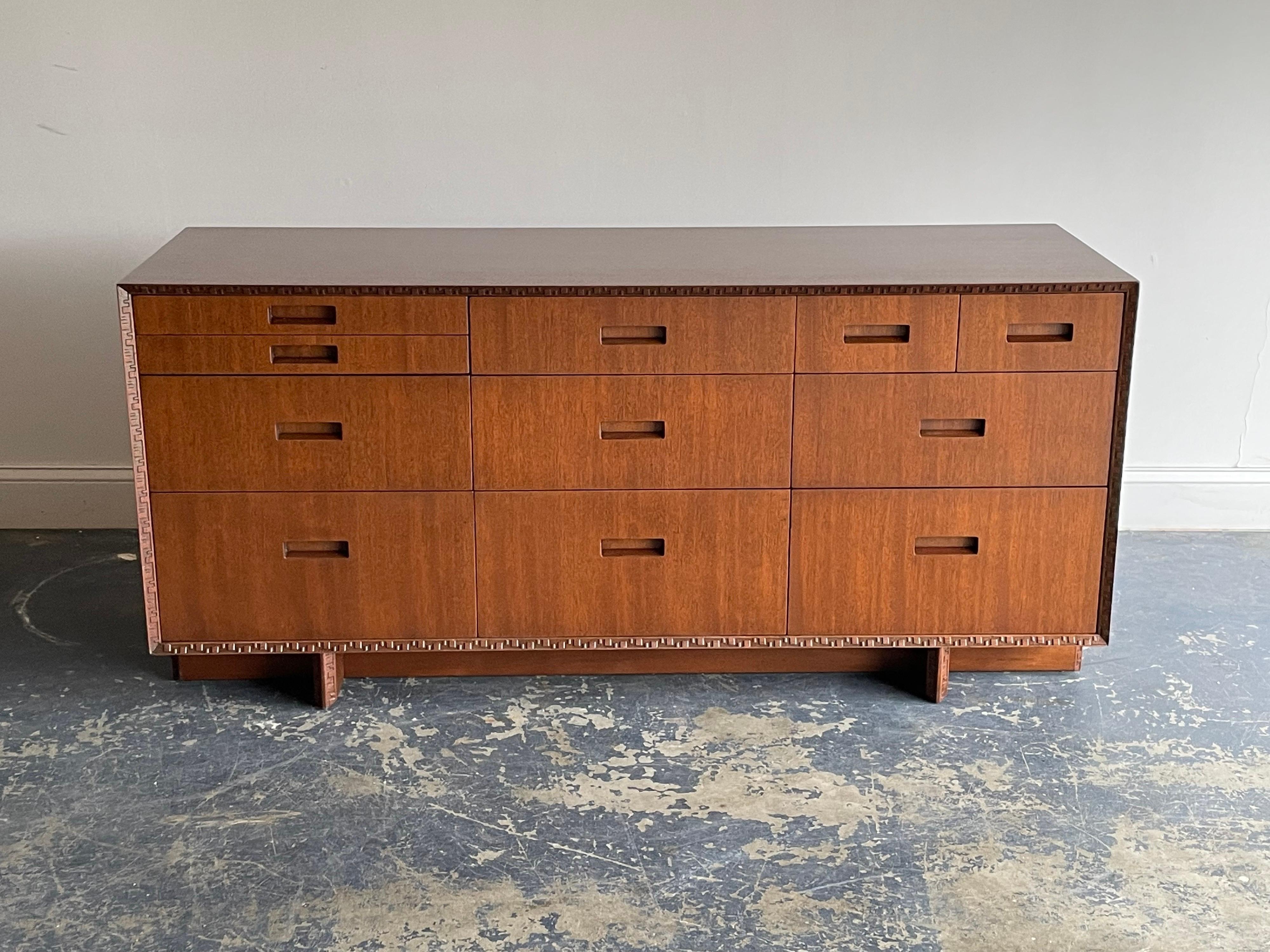 Rare cabinet designed by Frank Lloyd Wright. Exceptional mahogany grain and iconic Taliesin border. This is a versatile piece which could work in a variety of settings.