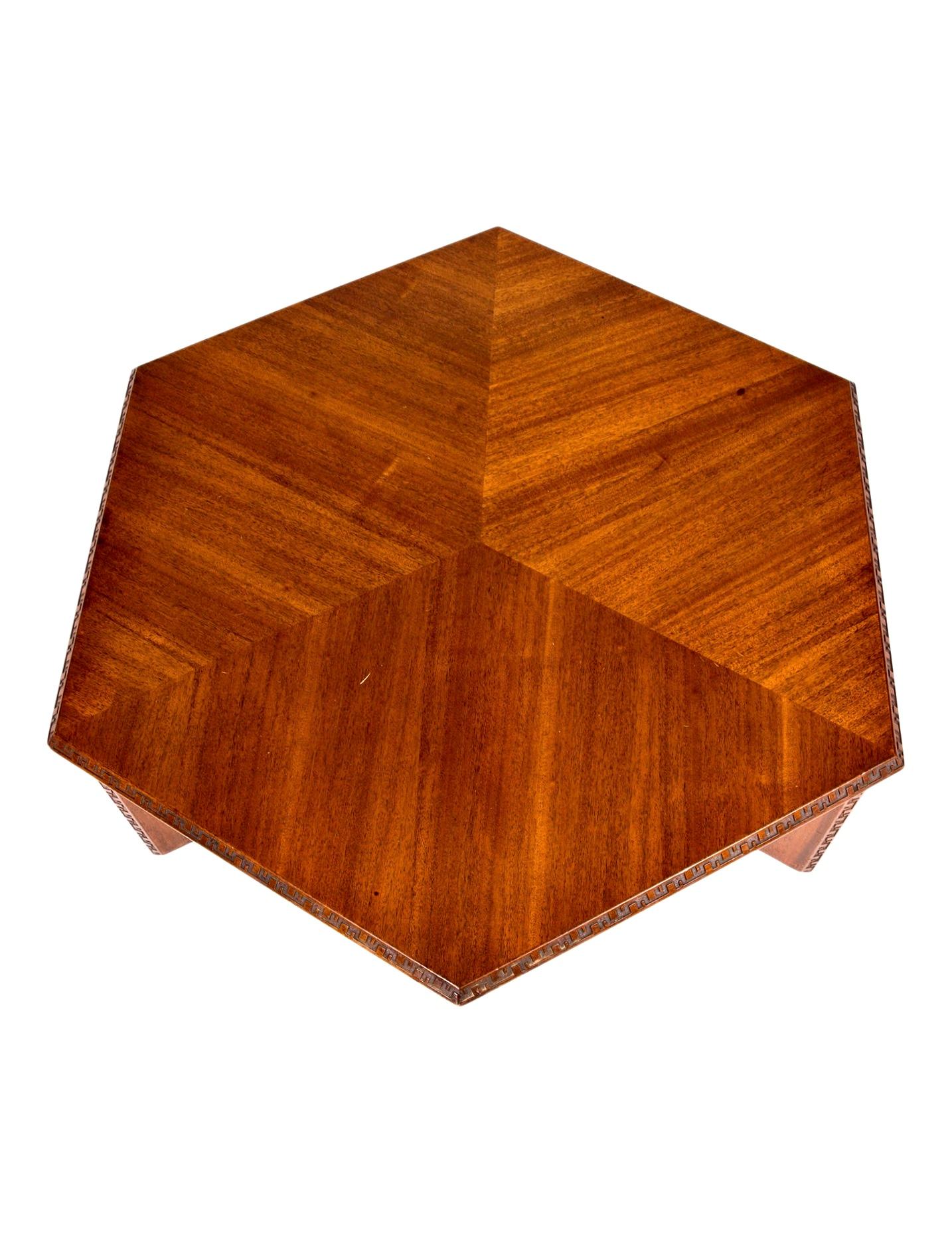 Frank Lloyd Wright Heritage Henredon Taliesin Hexagonal mahogany coffee table, 1955 

Mahogany Frank Lloyd Wright Taliesin coffee table with hexagonal form, carved geometric pattern at apron and sides, slab legs.

In 1955 Frank Lloyd Wright