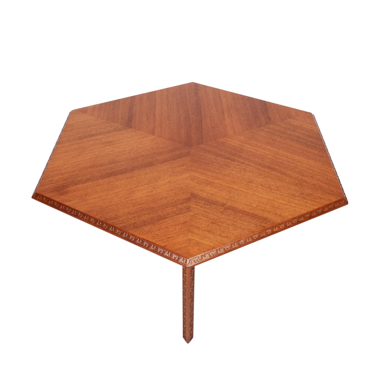 Mahogany six-sided coffee table with Taliesen designed hand-curved edge. Signed with manufacturer's mark. Made by Heritage Henredon.