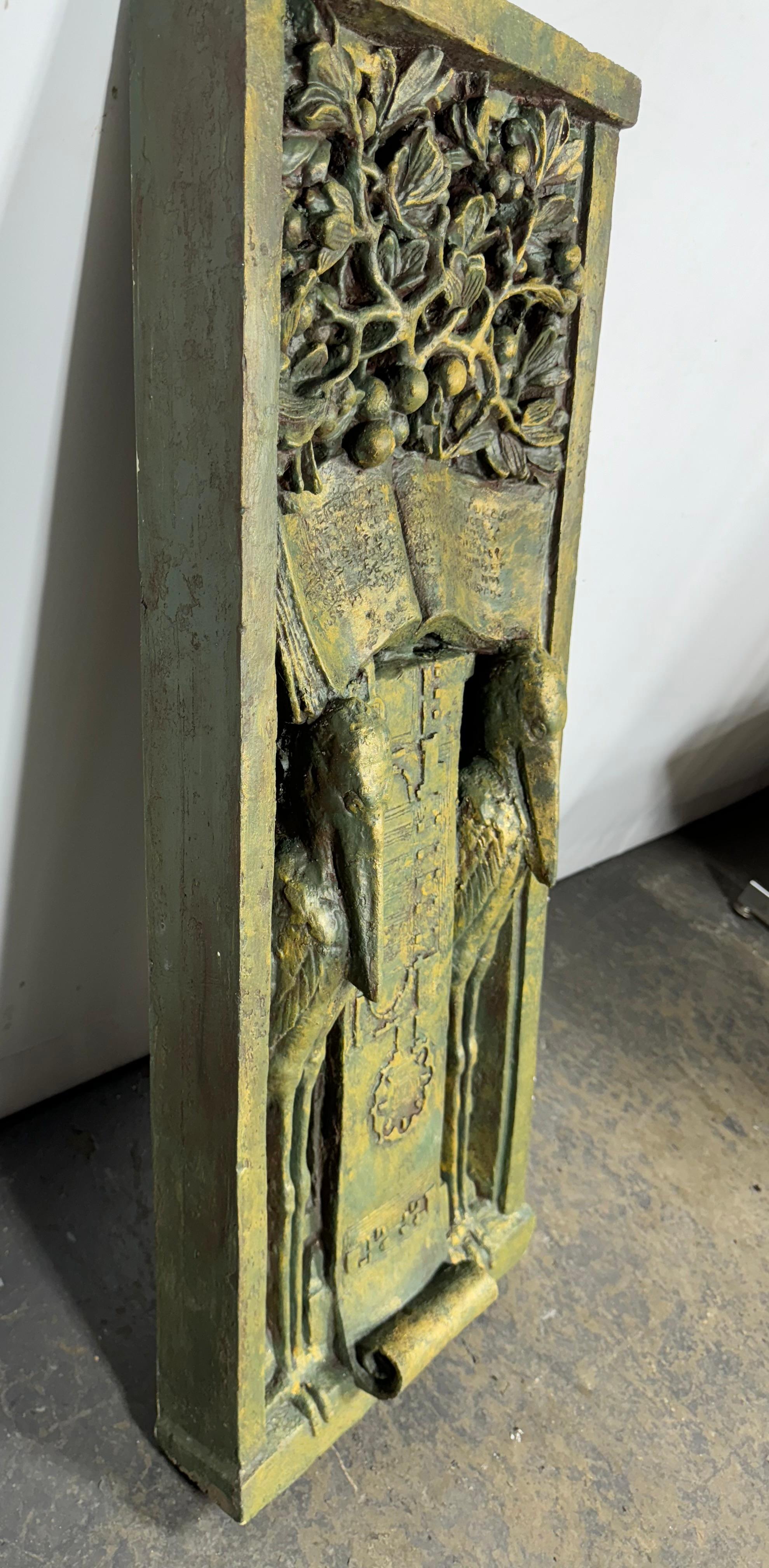 Frank Lloyd Wright Home & Studio foundation Ornamental Cast relief featuring two storks flanking a blueprint beneath a book of aphorisms crowned with fruiting tree branches.. The originals were designed and made for one of Frank Lloyd Wrights
