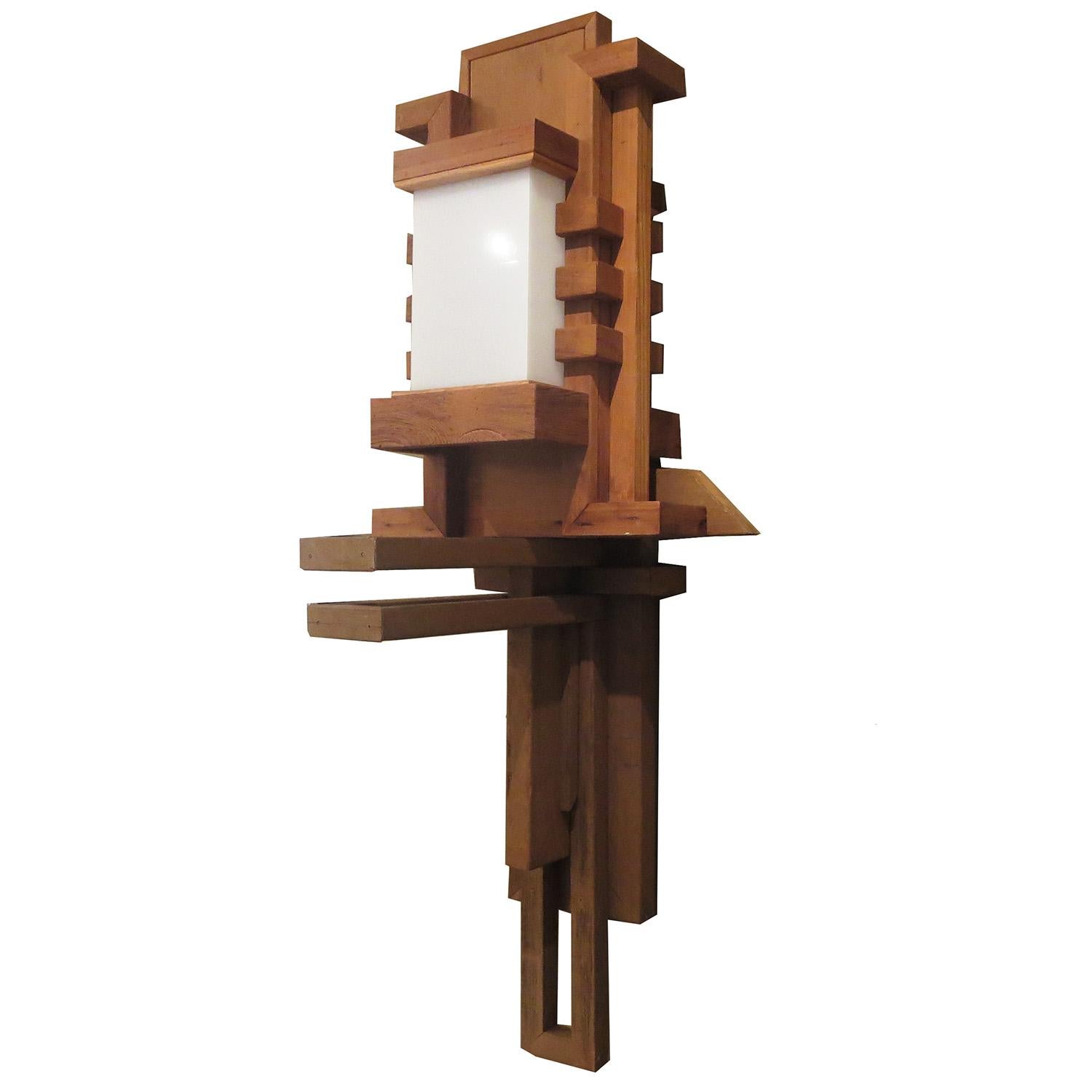 This incredible Frank Lloyd Wright inspired wall lamp was created for a 1950s La Crescenta, California modern home. The lamp and entire home, were an obvious homage to Americas premier architect / designer Frank Lloyd Wright. The fixture is